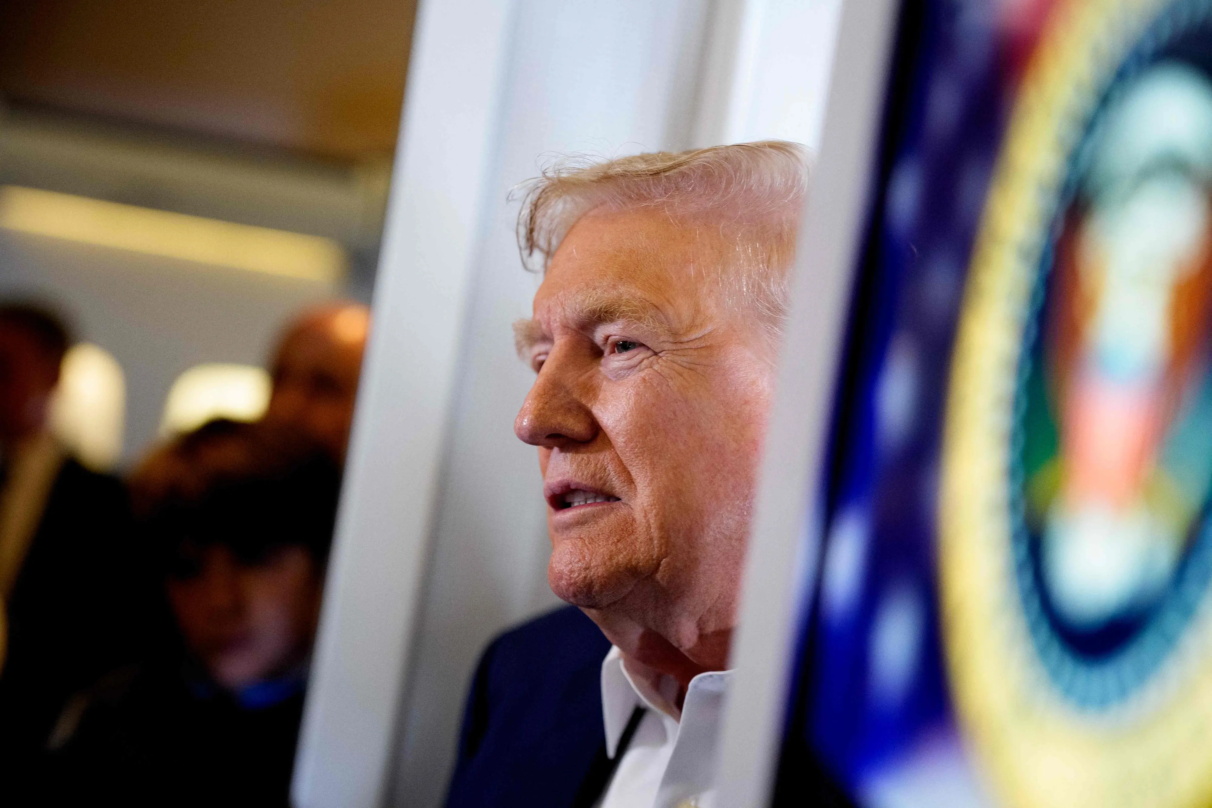 U.S. President Donald Trump speaks to members of the media aboard Air Force One on July 29, 2025 in flight | Photo: AFP