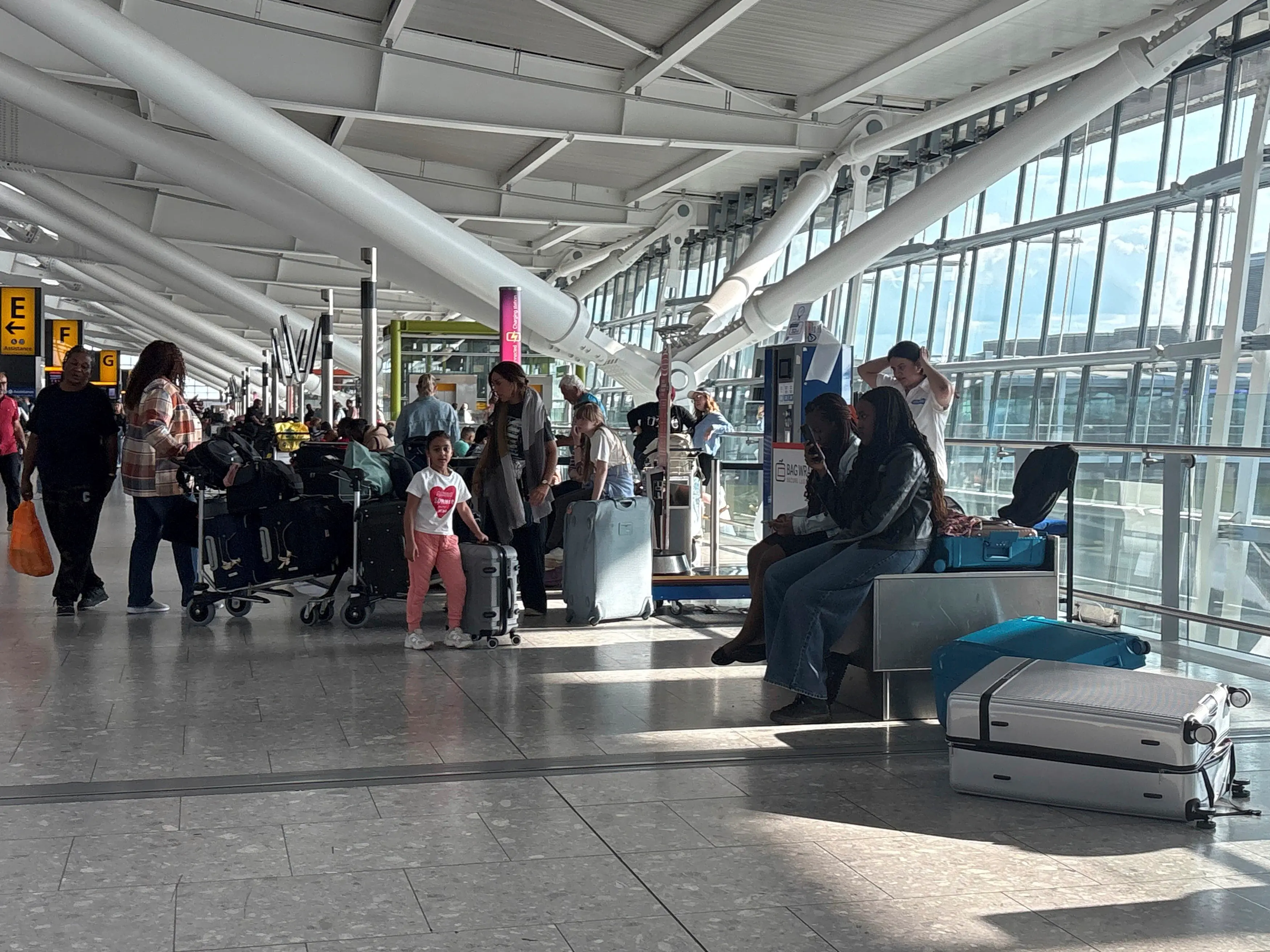 Passengers stand inside T5 at Heathrow airport after an air traffic control (ATC) fault caused major disruption | Photo: AP