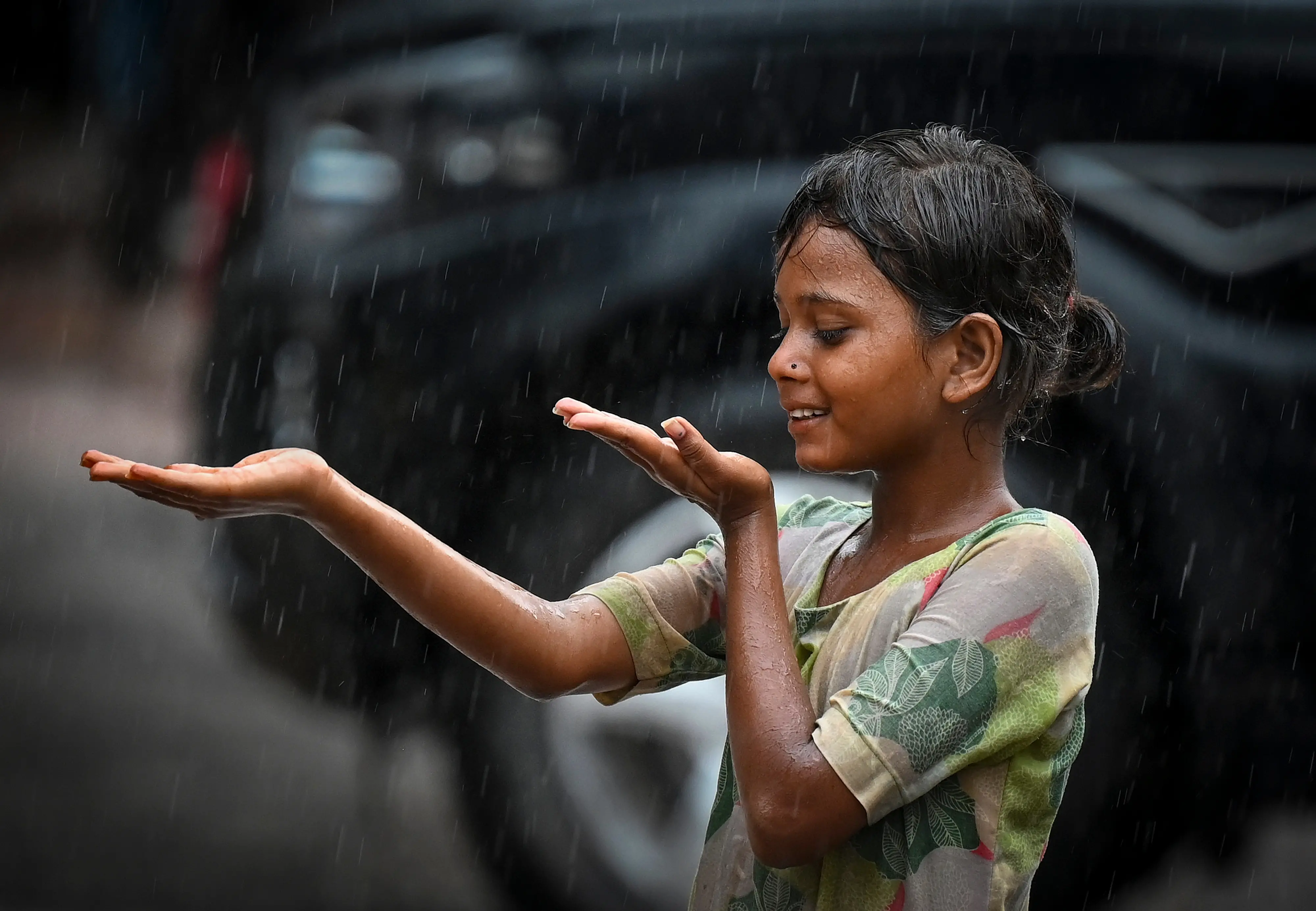 Bikaner: A girl plays in rain, in Bikaner, Rajasthan. | Photo: PTI