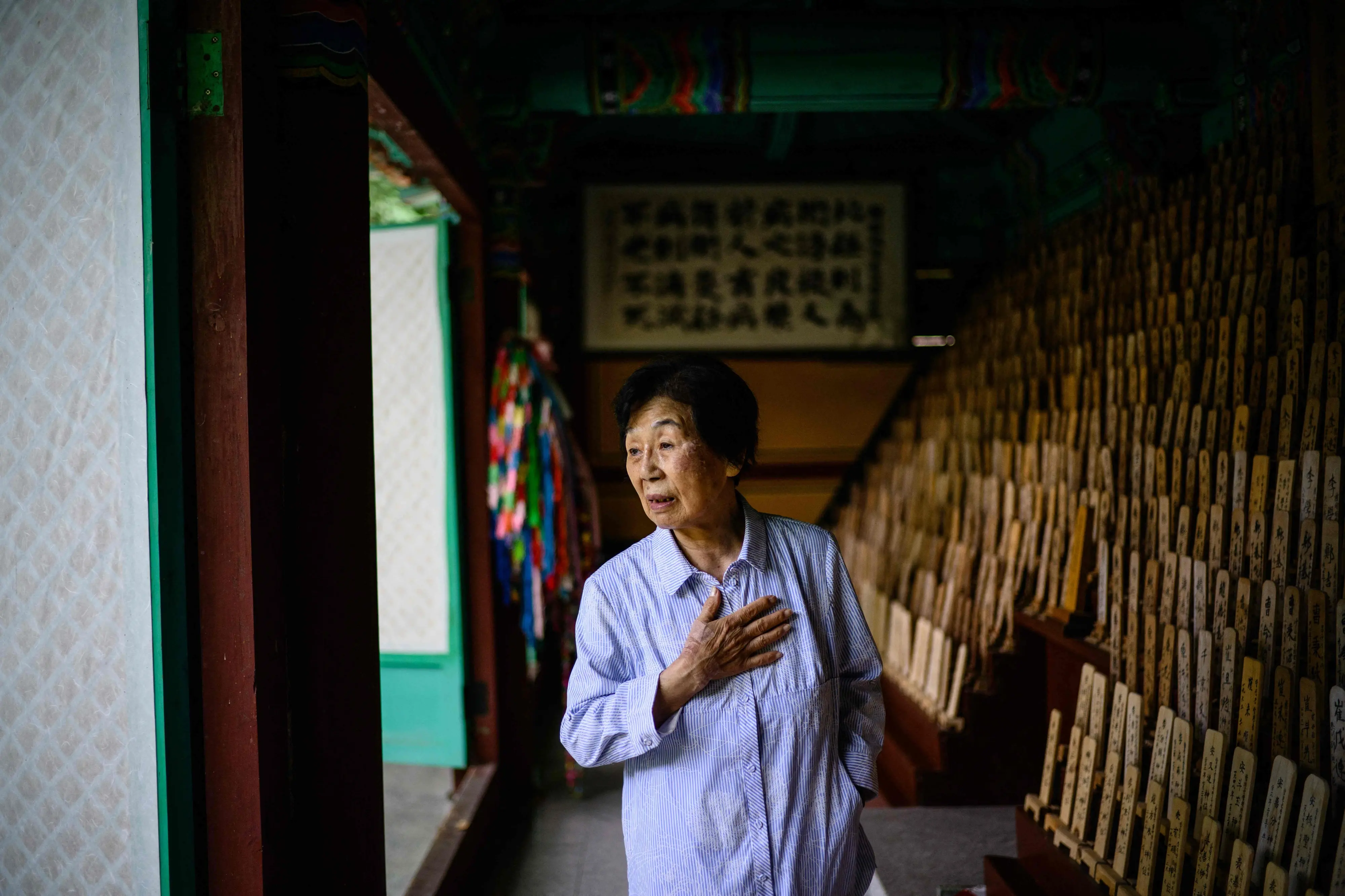 Hiroshima atomic bomb survivor Bae Kyung-mi visiting a traditional structure holding 1,172 wooden plaques bearing the names of deceased victims -- among them Bae's three siblings -- behind the Hapcheon Atomic Bomb Victim Welfare Center, opened in 1996 by the Korean Red Cross with funding from both South Korean and Japanese governments, providing round-the-clock service to survivors of the World War II atomic bombings seeking help | Photo: AFP
