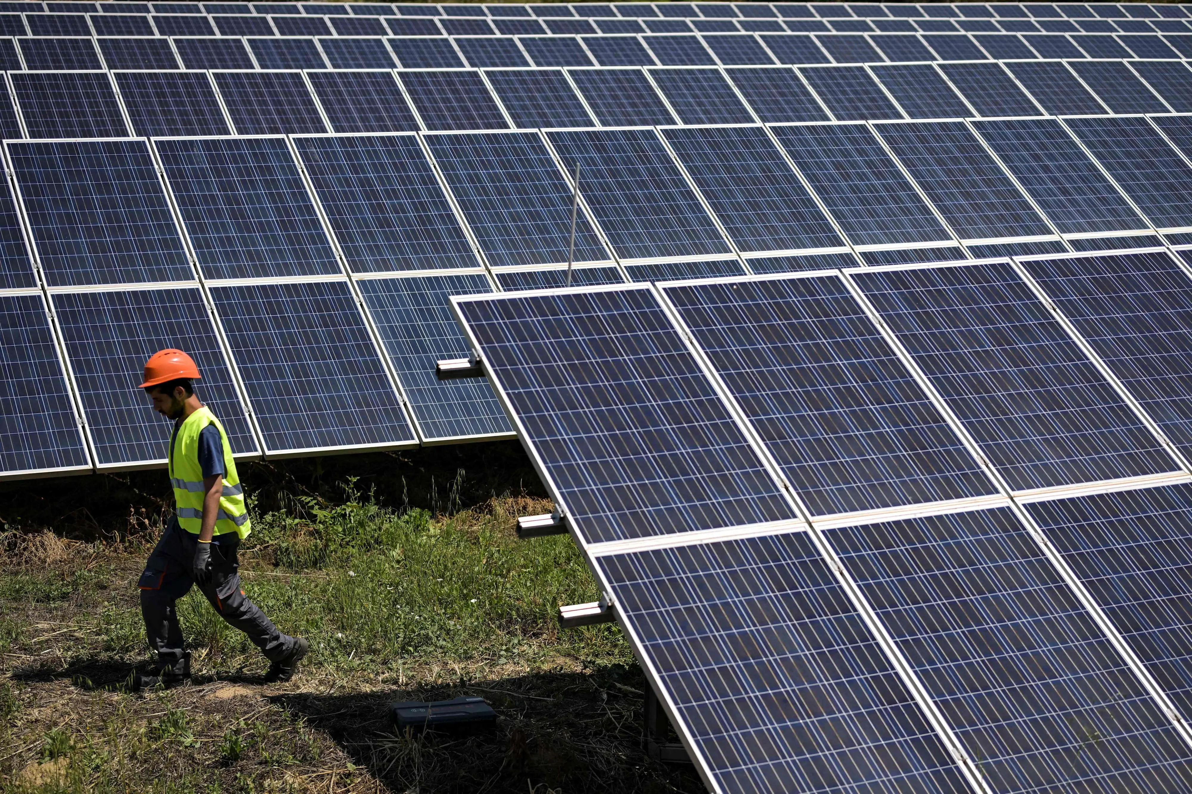 Worker near solar panel