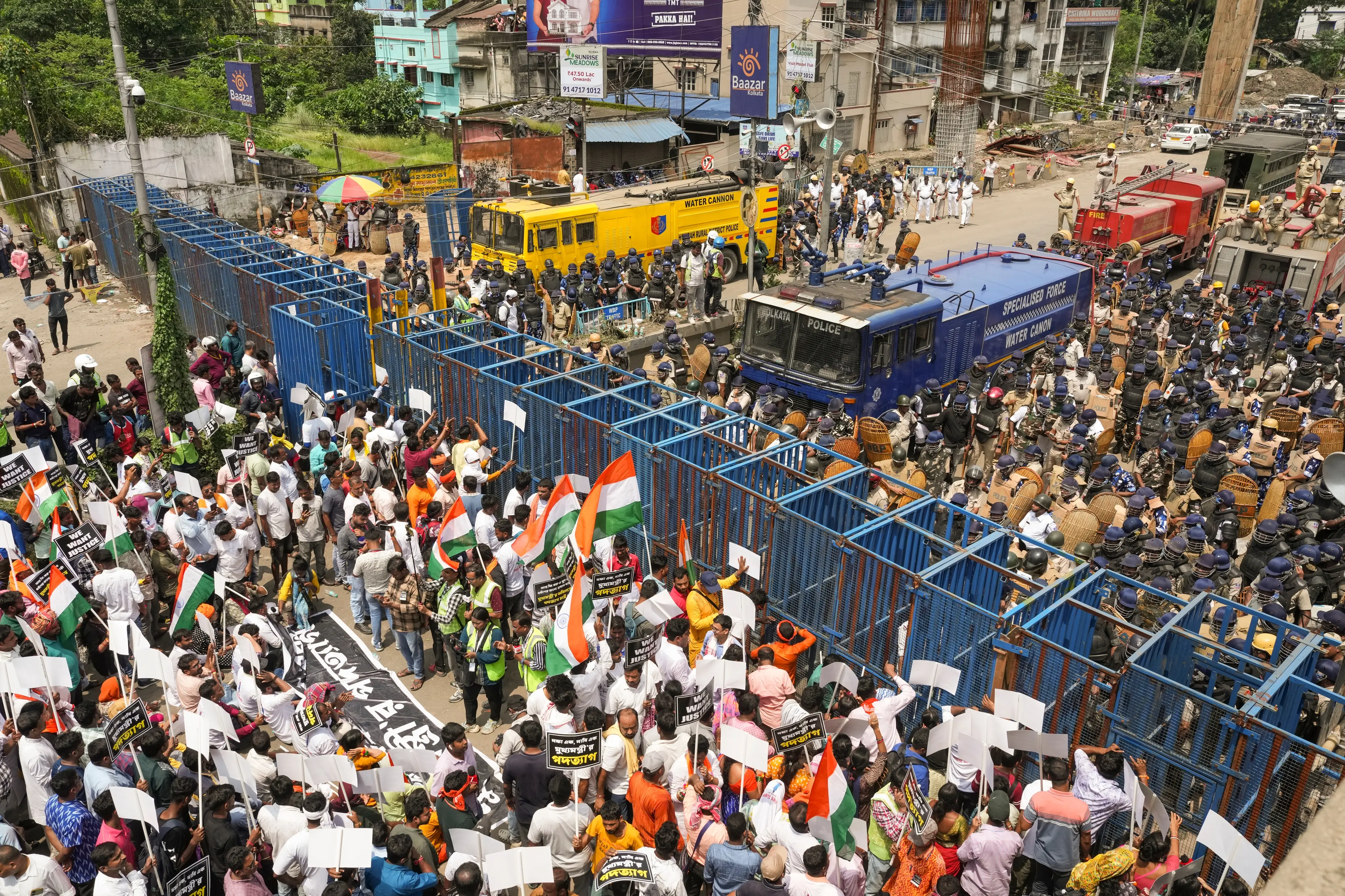 Protestors taking part in a march to the West Bengal secretariat 'Nabanna' to mark the completion of one year of the rape and murder of a trainee doctor at RG Kar hospital, near the iron wall barricades set up by the city police, at Santragachi in Howrah district of West Bengal | Photo: PTI