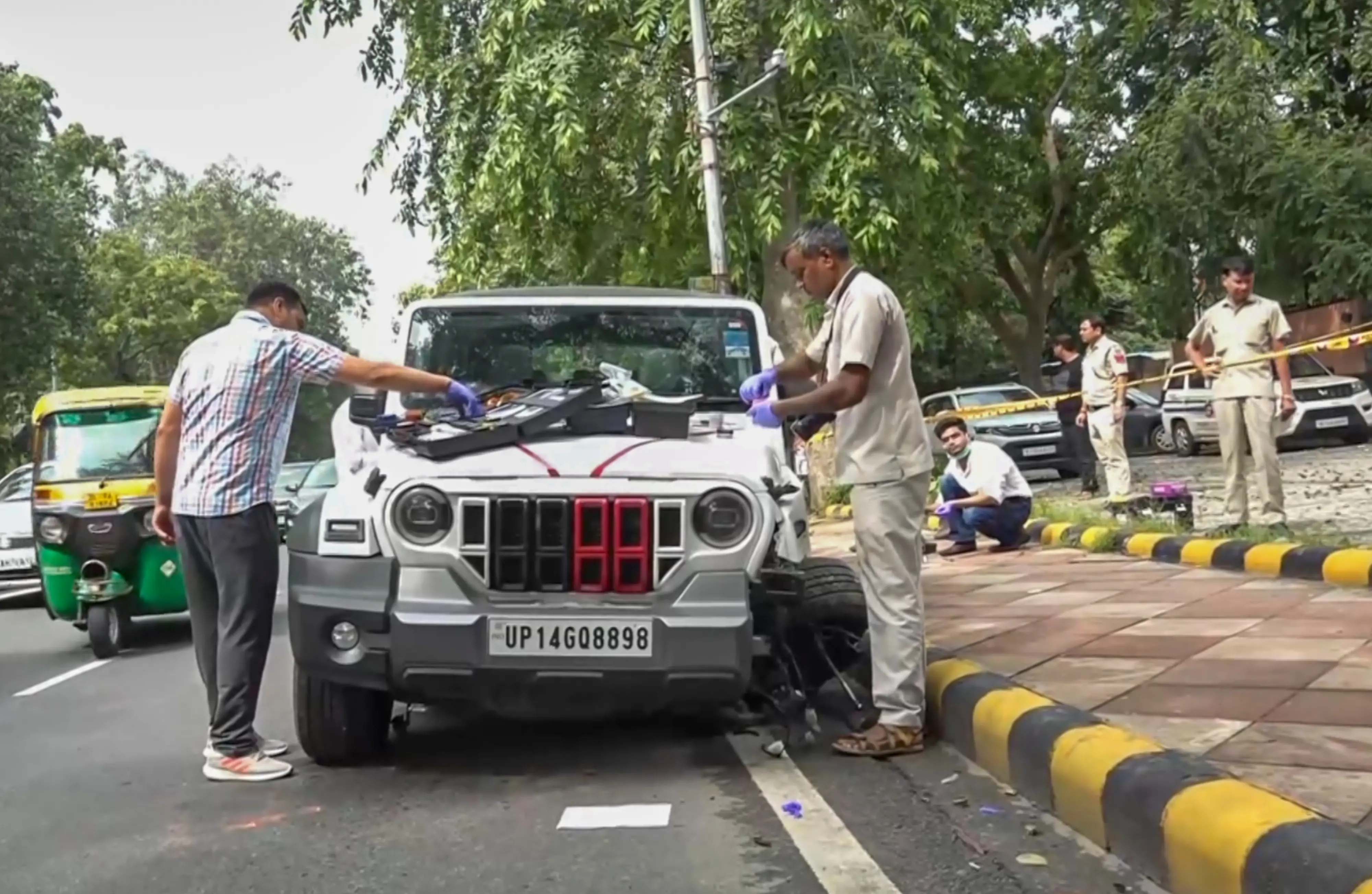 Police personnel and forensic experts at the site after a speeding white Thar killed one person and injured another on Mother Teresa Road in New Delhi | Photo: PTI
