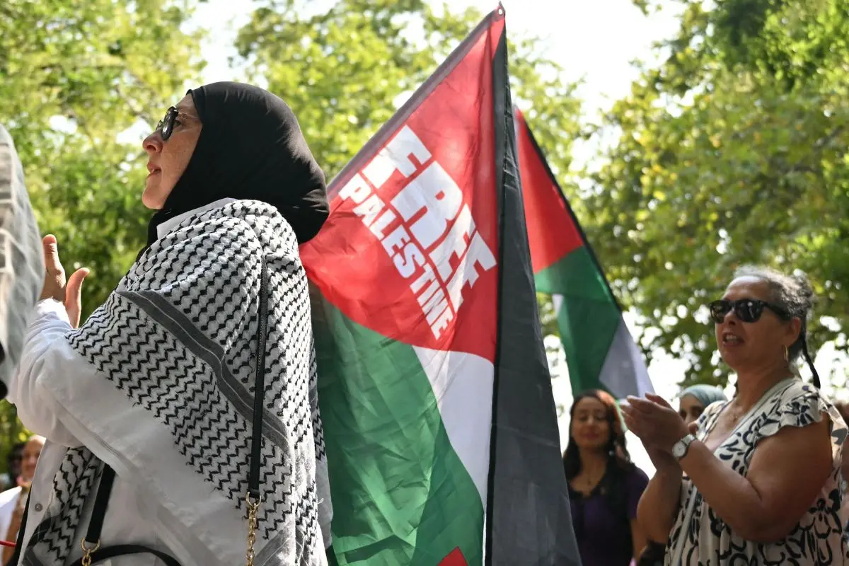 A demonstrator holds a Palestinian flag reading 'Free Palestine', during a pro-Palestinian gathering entitled 'stop genocide rally' at Bastille Square in Paris on August 9, 2025 (Photo: AFP)