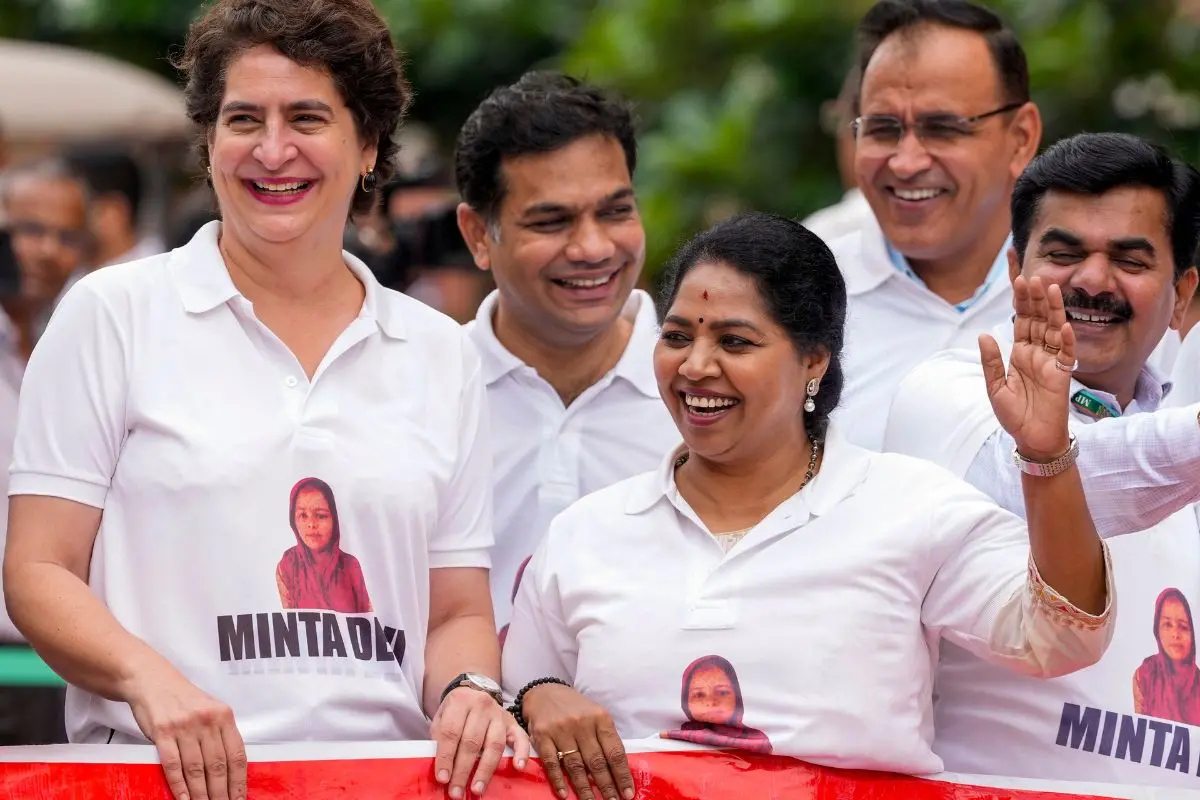 Congress MPs Priyanka Gandhi Vadra and R. Sudha seen wearing T-shirts featuring the name Minta Devi, a voter allegedly listed as 124 years old in the Election Commission's voter list, during a protest by INDIA bloc members over issues of alleged 'poll fraud' and Special Intensive Revision of electoral rolls, at the Monsoon session of Parliament, in New Delhi. | Photo: PTI