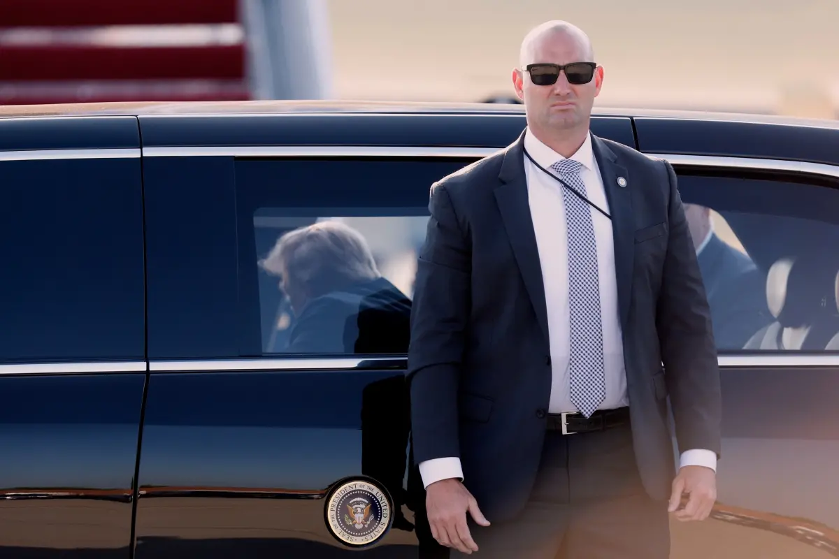A US Secret Service agent, right, stands next to President Donald Trump's limousine | Photo: AP