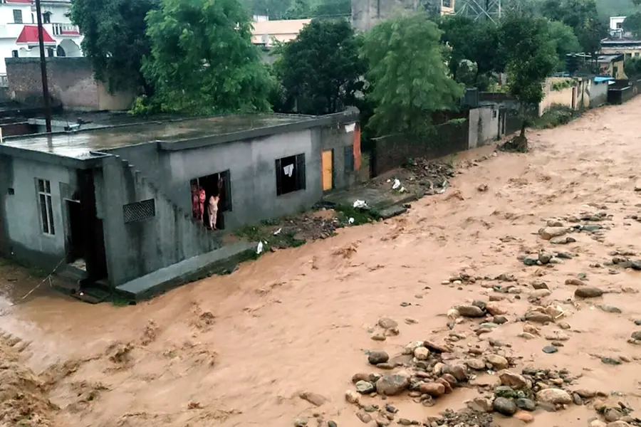 Debris and mud accumulated in a residential area following a cloudburst, in Kathua,