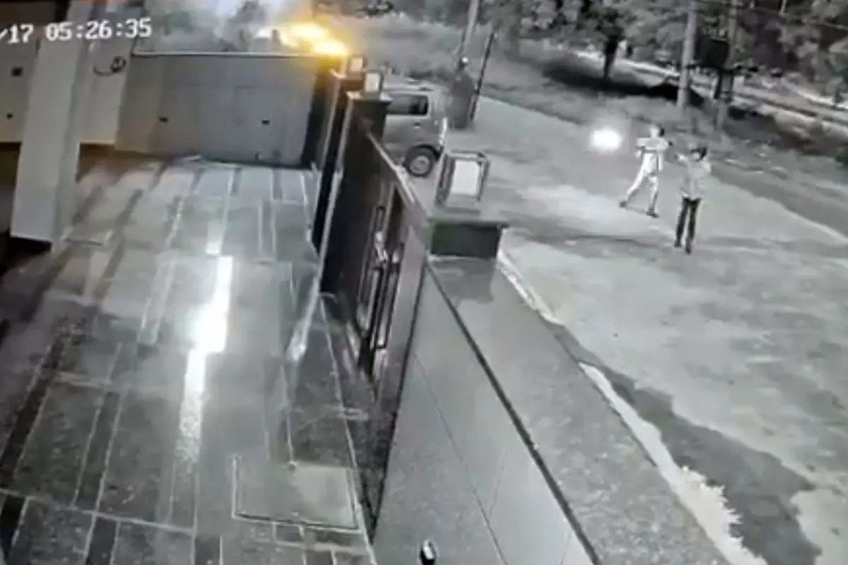 CCTV grab shows two gunmen opening fire at the Gurugram residence of Elvish Yadav