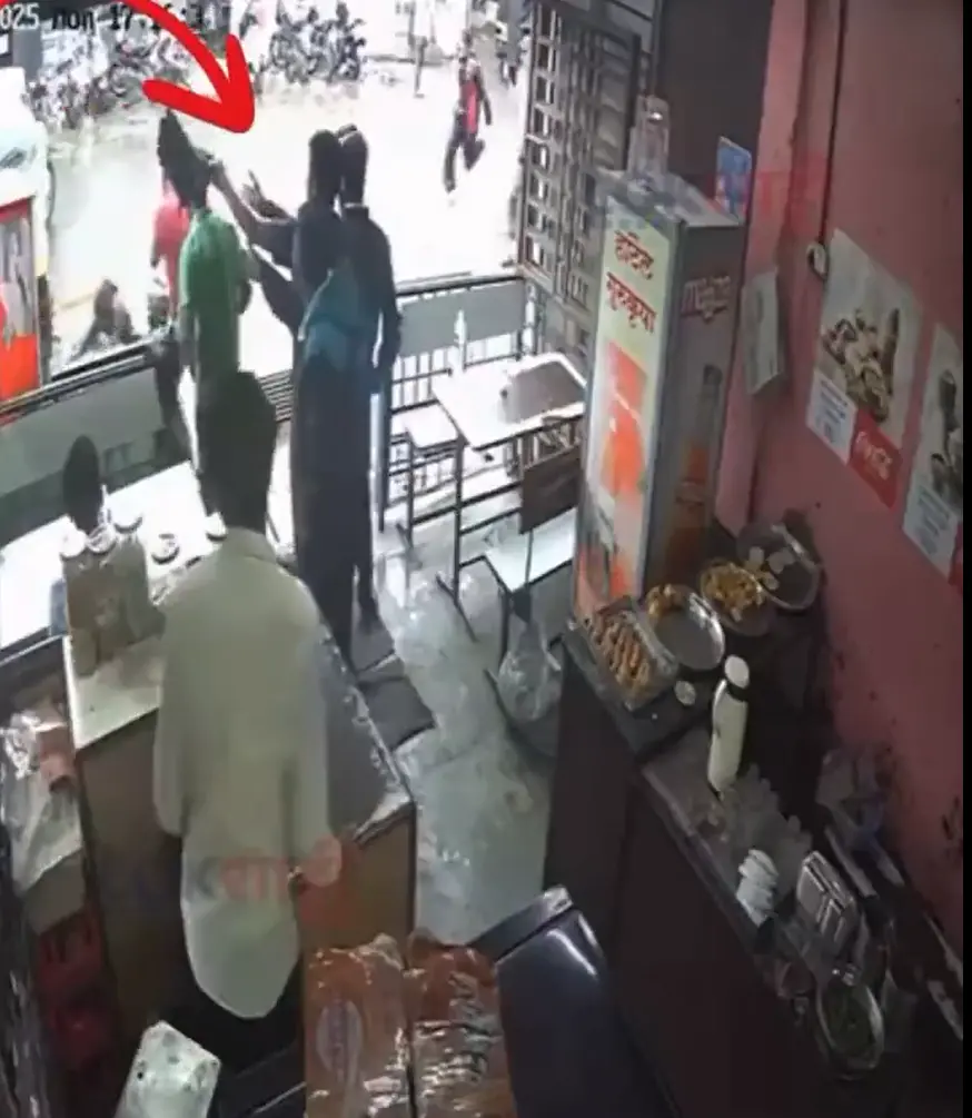 Video screengrab from CCTV footage of the female police officer being dragged by auto driver | X