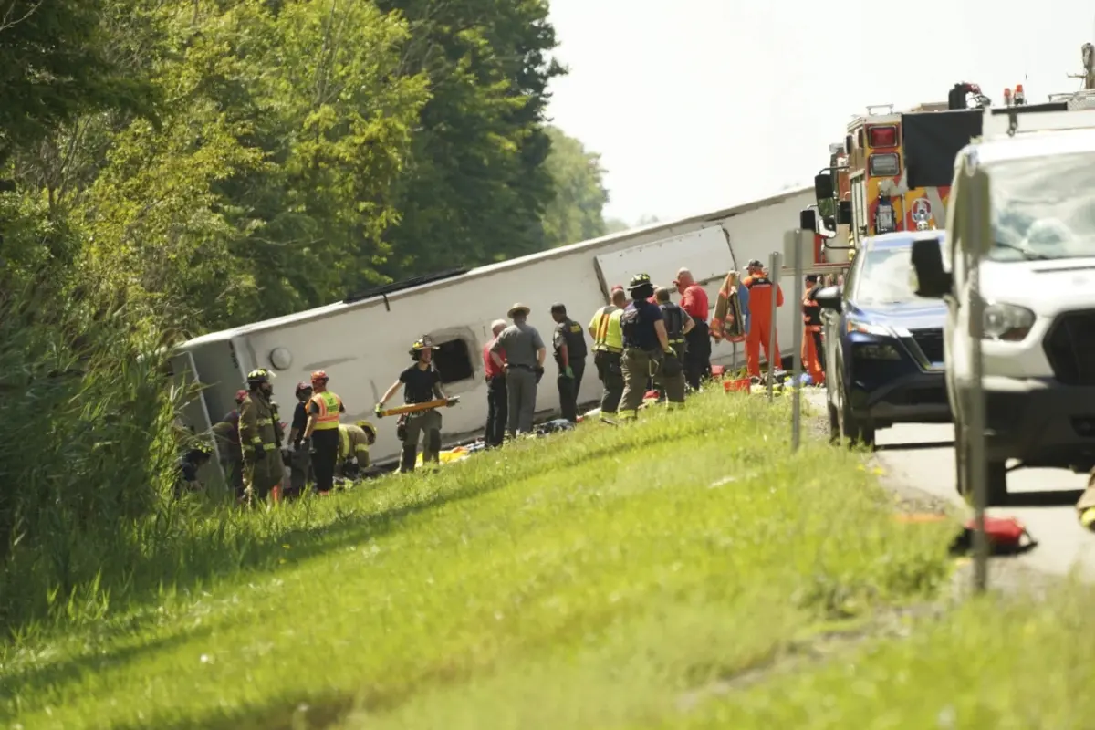 First responders work to rescue victims at the scene of a tour bus that crashed and rolled over on the New York State Thruway near Pembroke | Photo: AP