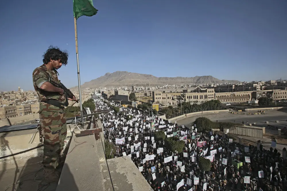 A soldier stands guard as Houthi supporters attend a demonstration against the United States over its decision to designate the Houthis a foreign terrorist organization in Sanaa, Yemen | File photo: AP