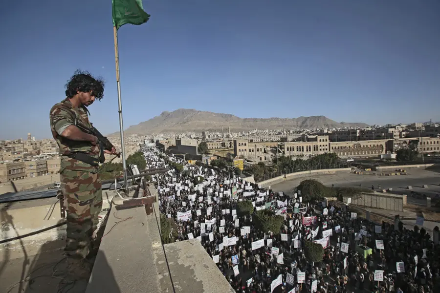 A soldier stands guard as Houthi supporters attend a demonstration against the United States over its decision to designate the Houthis a foreign terrorist organization in Sanaa, Yemen