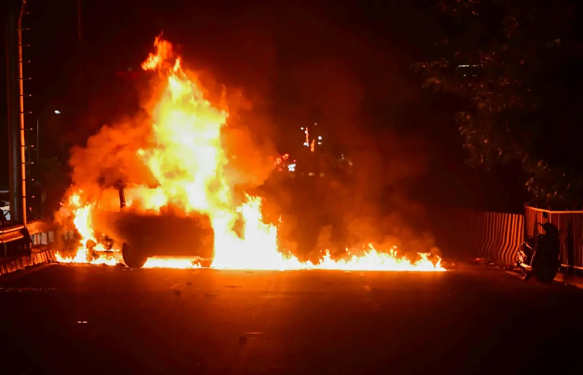 Protestors set vehicle on fire during a protest | Photo: ANI