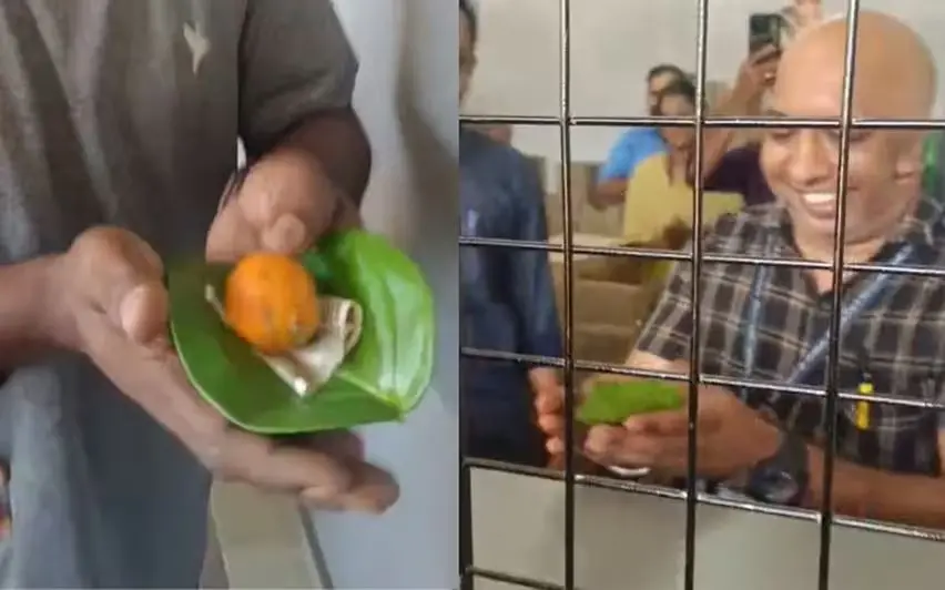 Ranju, the first customer at the reopened Ponkunam BEVCO outlet, offers dakshina with betel leaf