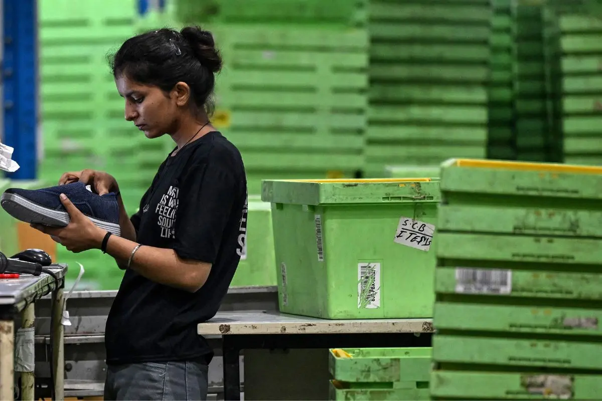 A worker scans packages ahead of dispatch at Sanpka in Haryana. Representative photo: AFP