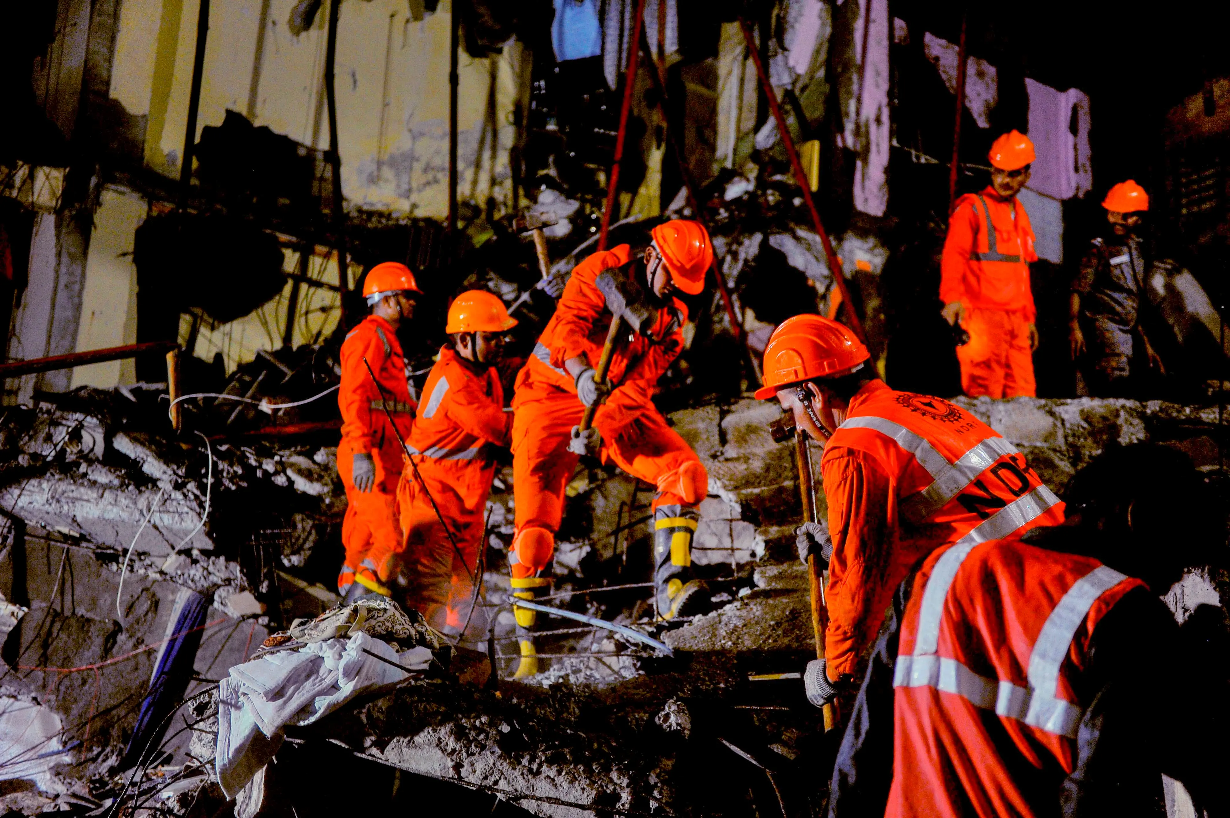 NDRF personnel during a rescue operation after the rear portion of a four-storey building crashed onto a chawl at Virar | PTI