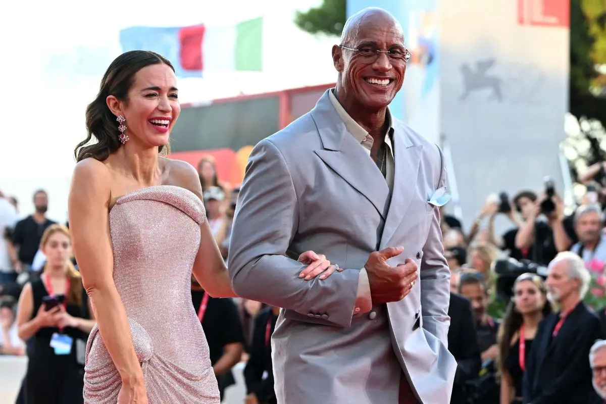 British actress Emily Blunt and US actor and wrestler Dwayne Johnson attend the red carpet of the movie 'The Smashing Machine' presented in competition at the 82nd International Venice Film Festival, at Venice Lido on Sepember 1, 2025. (Photo by Stefano RELLANDINI / AFP)