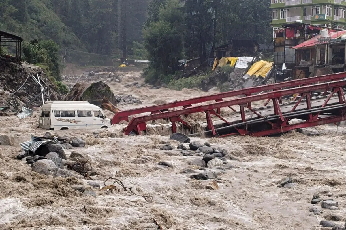 A vehicle stuck in Manalsu drain, flowing in spate, after heavy monsoon rain (Photo: PTI)