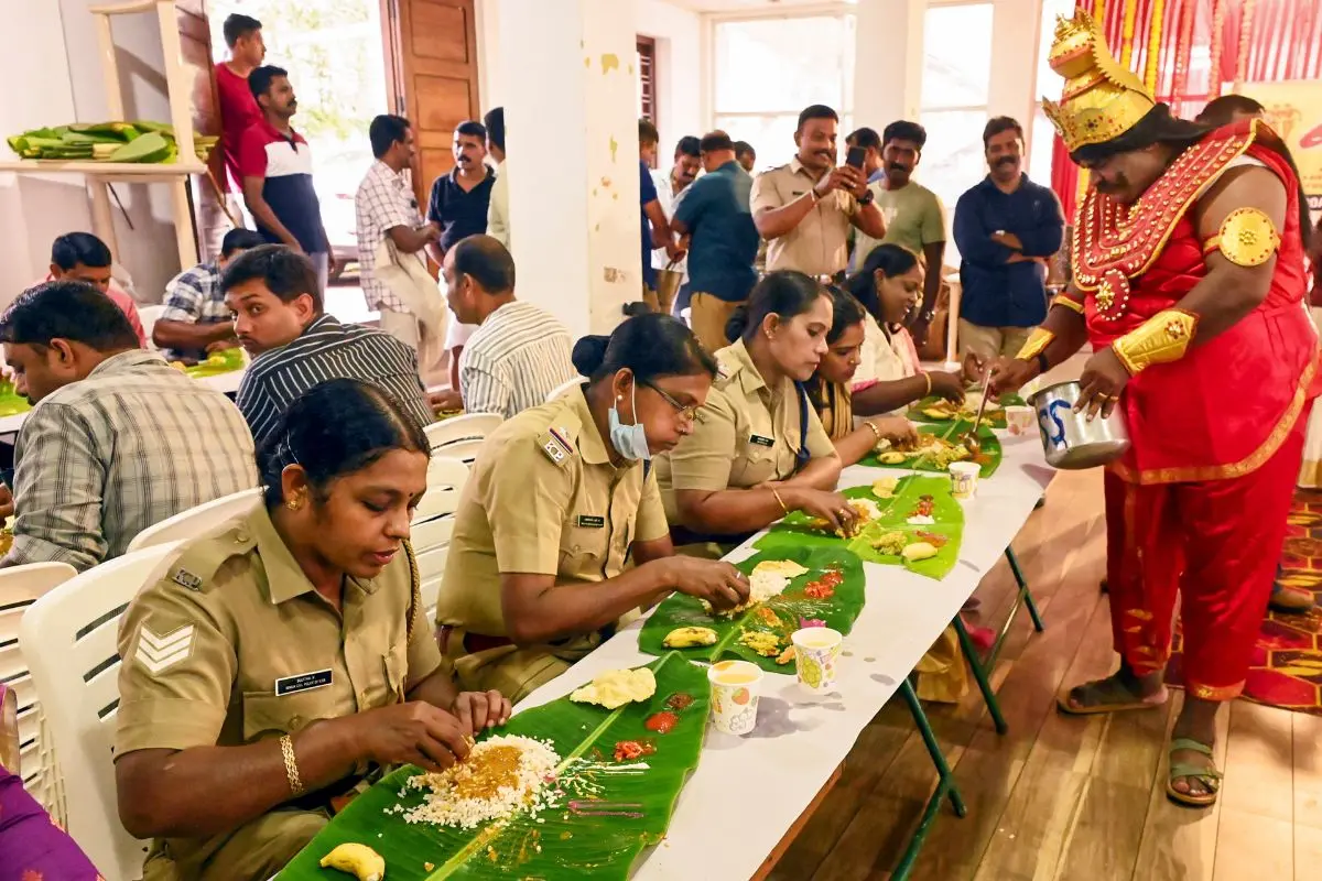 A man dressed as King Mahabali serves 'Onam Sadya', a traditional feast served on a banana leaf, to police personnel ahead of the Onam festival, in Thiruvananthapuram. Photo: PTI
