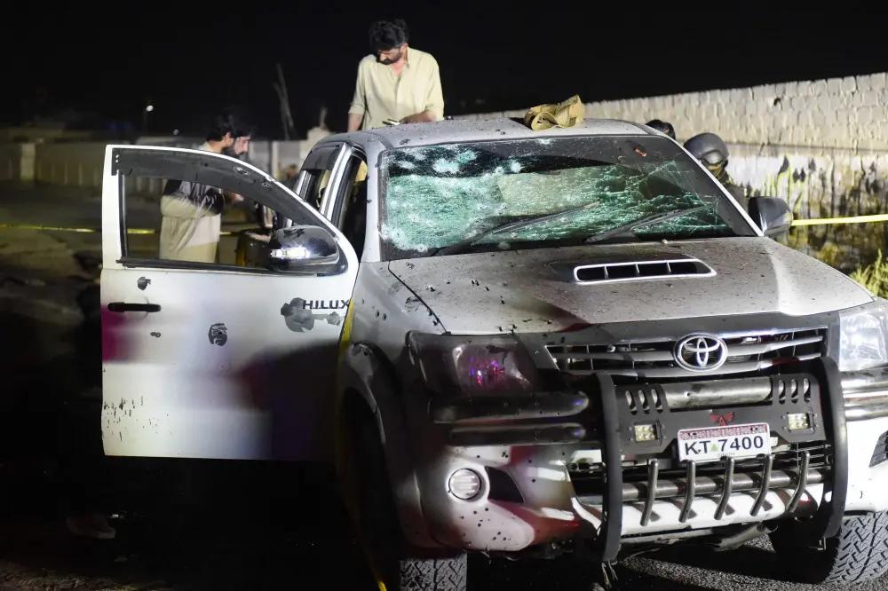 Security personnel inspect a damaged vehicle at the site of an explosion after a suicide bombing in Quetta | AFP