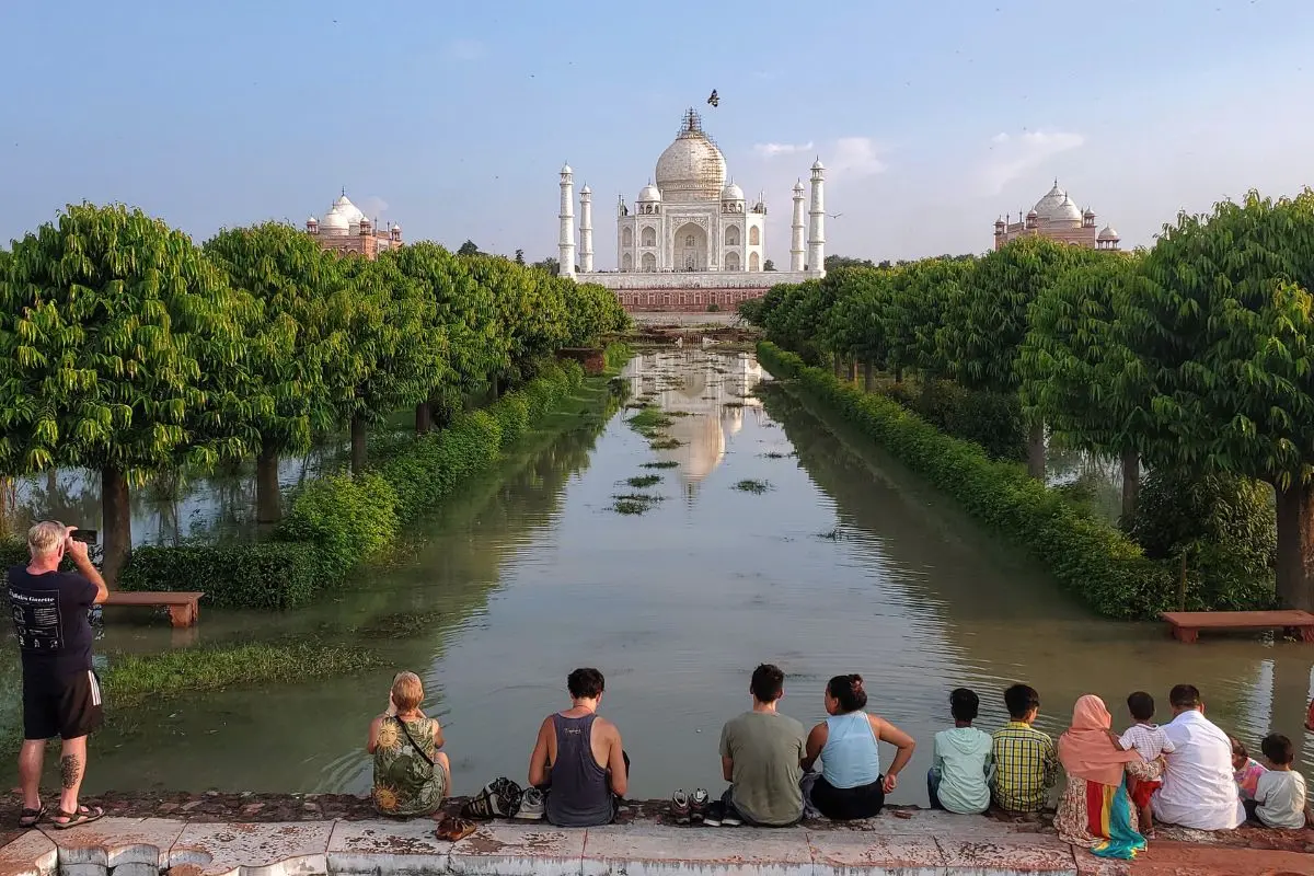 People enjoy a scenic view of the Taj Mahal form the waterlogged Mehtab Bagh, in Agra on Sunday | Photo: ANI