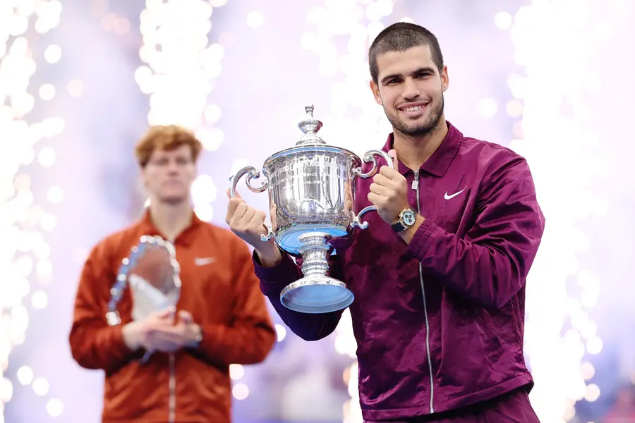 Carlos Alcaraz of Spain poses with his trophy after defeating Jannik Sinner of Italy