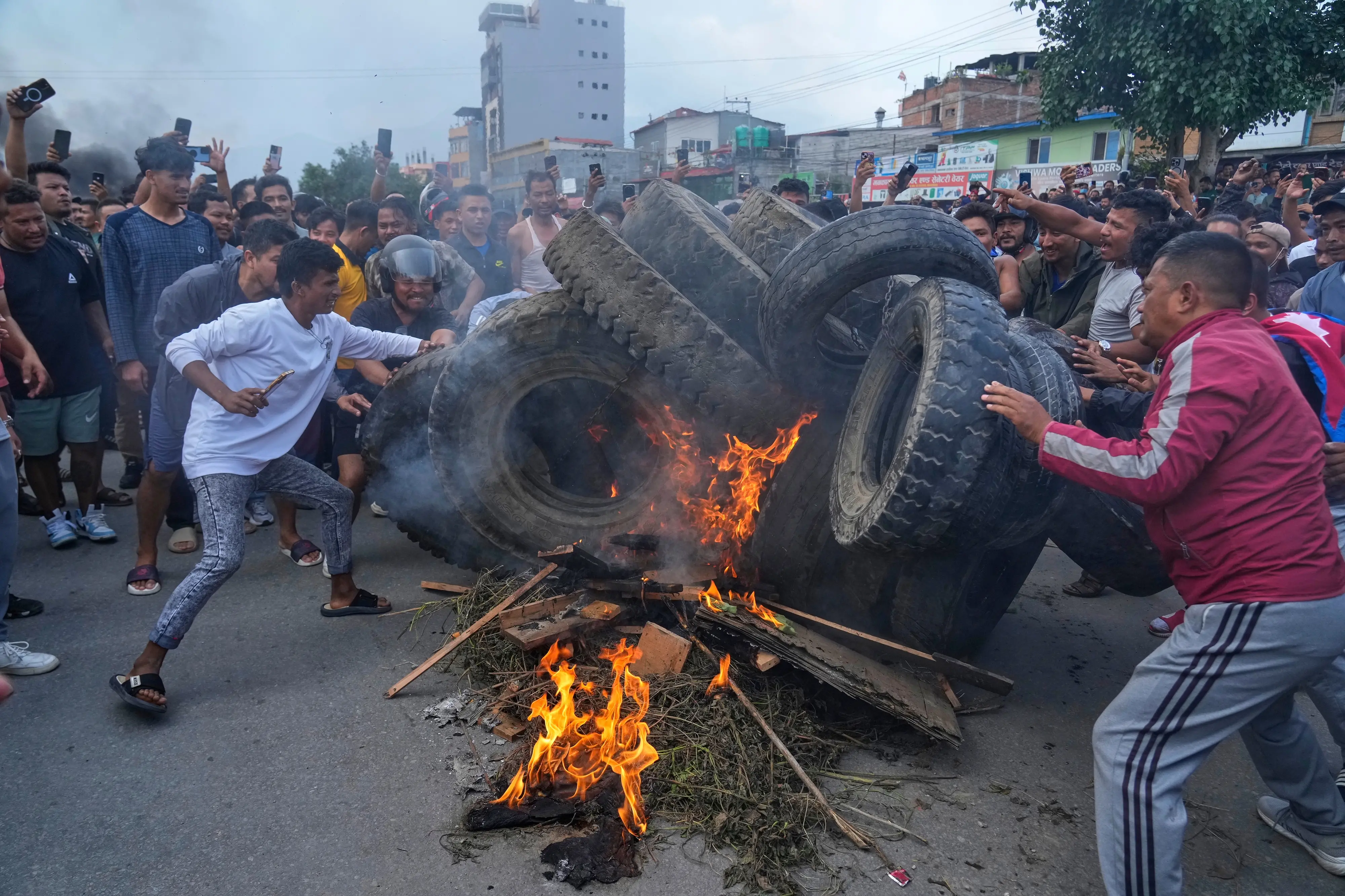 Protesters burn tires violating the curfew orders in Kathmandu, Nepal | AP