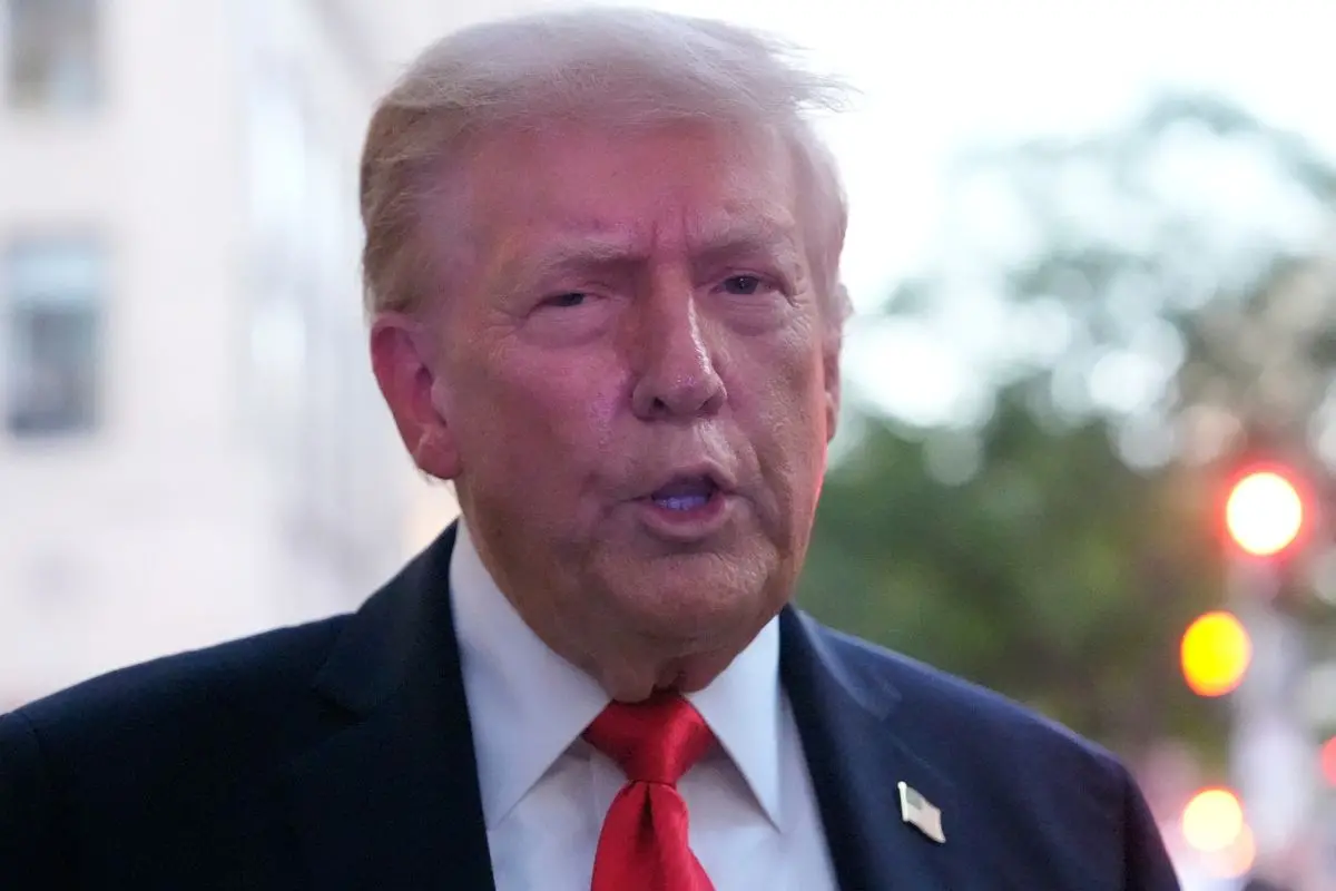 President Donald Trump speaks to reporters before he enters a restaurant near the White House, Tuesday, Sept. 9, 2025, in Washington, to have dinner. (AP Photo/Alex Brandon)