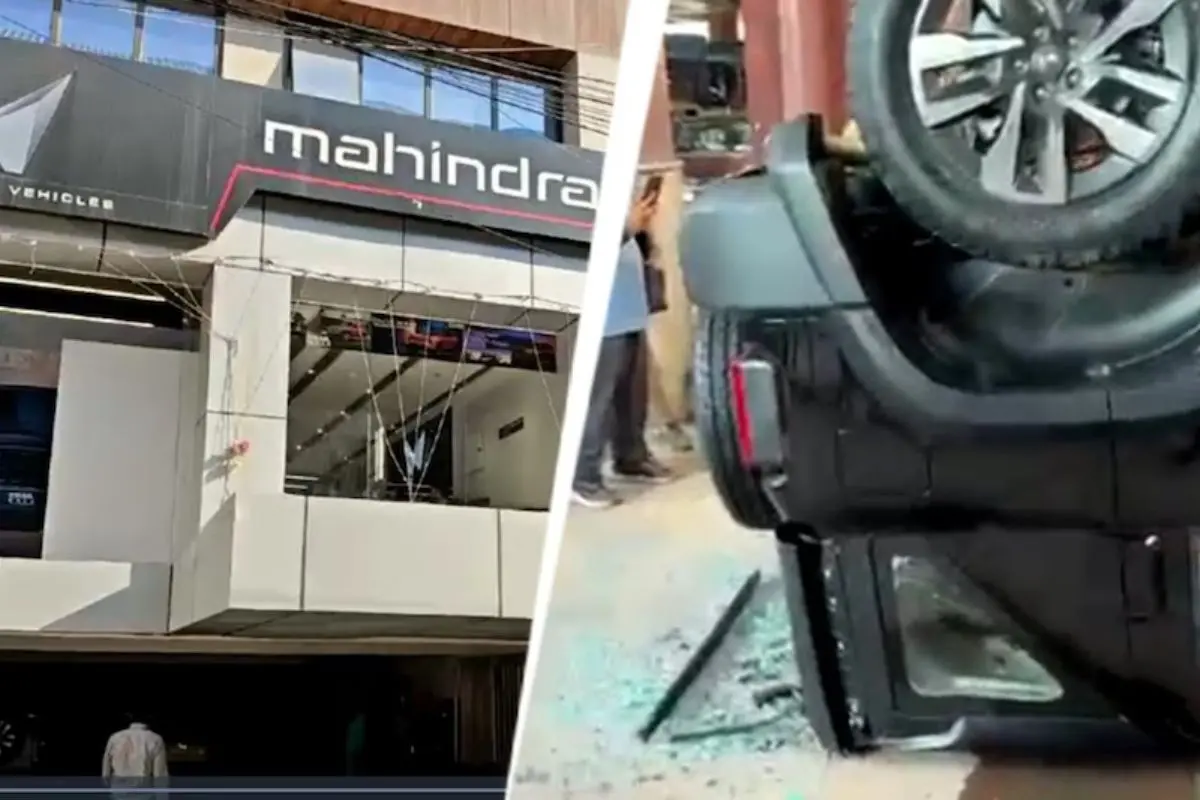 A brand-new Mahindra Thar lies overturned on the road after smashing through the glass wall of a first-floor showroom in Delhi's Preet Vihar. Miraculously, the couple inside escaped without serious injuries. Photo: X