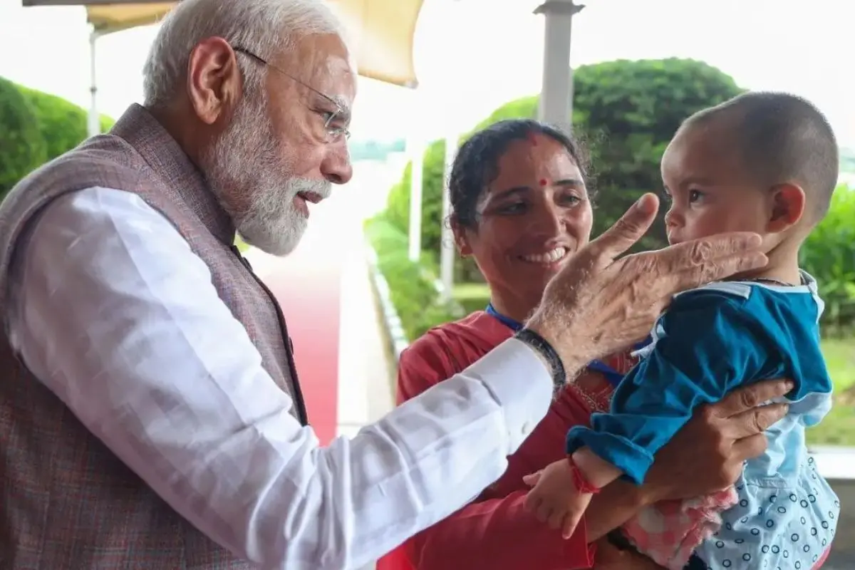 Prime Minister Narendra Modi with one-year-old Nitika, who lost her parents in the June 30 cloudburst in Mandi. | Photo: X