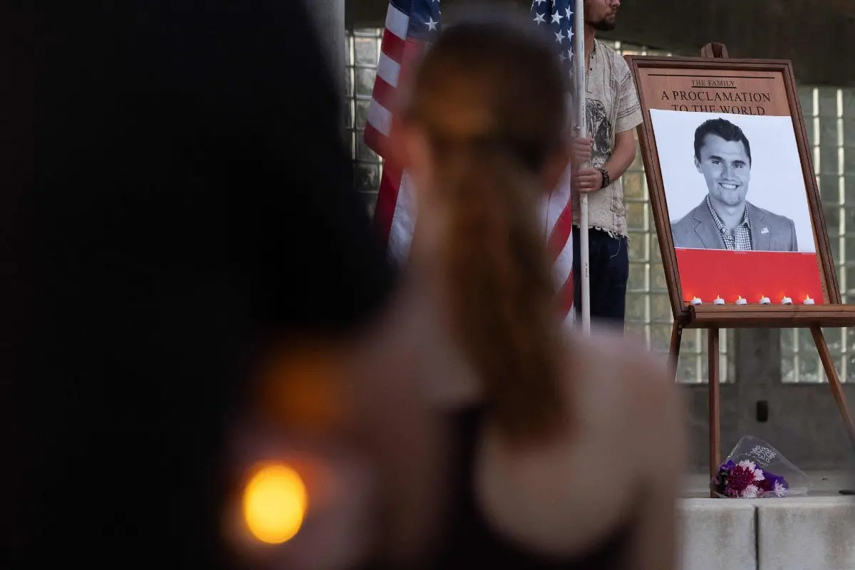 People attend a vigil for youth activist and influencer Charlie Kirk, who was shot at a public event at Utah Valley University, in Orem City Center Park, Orem, Utah, on September 10, 2025. (Photo by Melissa MAJCHRZAK / AFP)