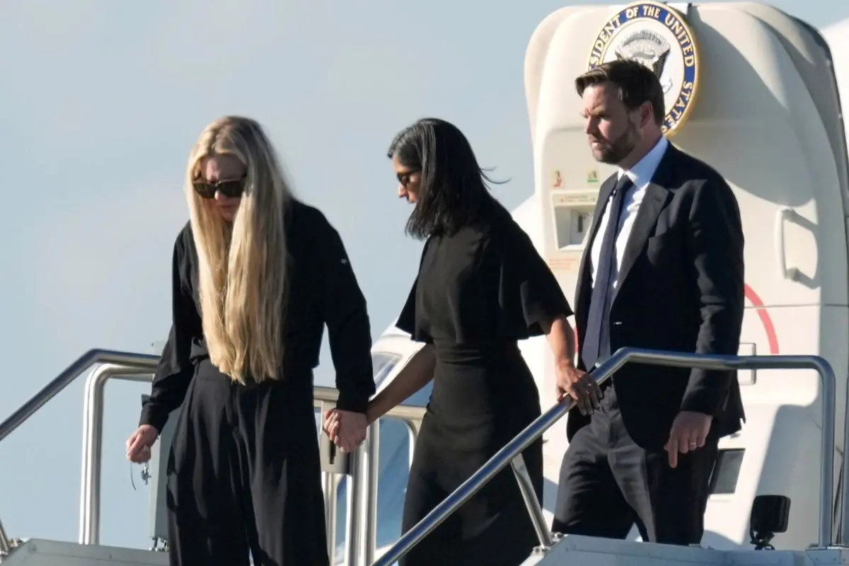 Vice President JD Vance, right, Second Lady Usha Vance, center, and Erika Kirk, holding a cross on a chain, deplane Air Force Two, carrying the body of Charlie Kirk (Photo: AP)