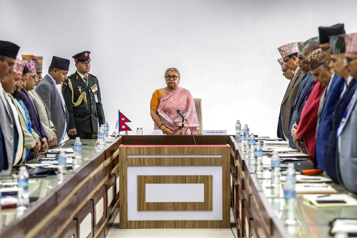 Newly-elected Prime Minister of Nepal's interim government Sushila Karki (C), along with officials. (Photo by PRABIN RANABHAT / AFP)