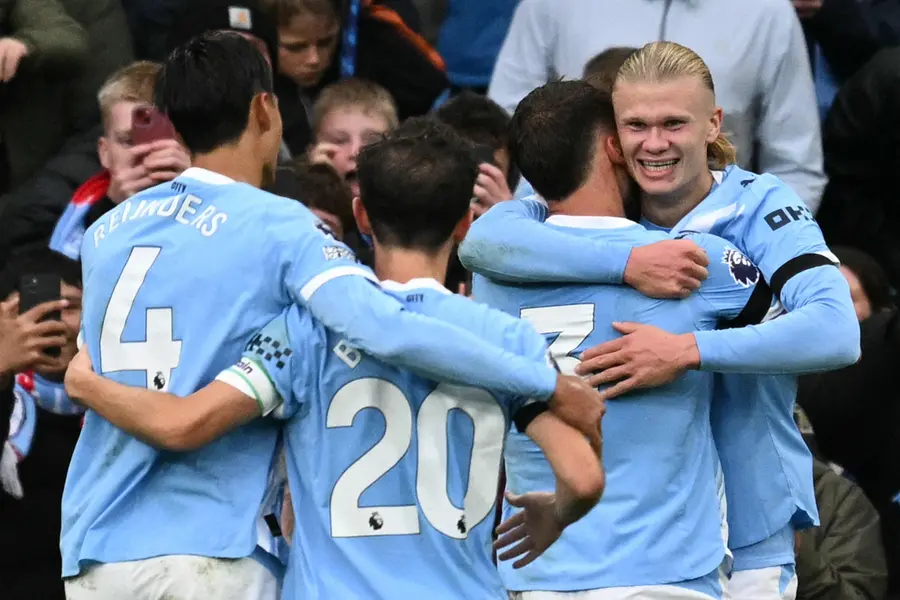 Erling Haaland (R) celebrates scoring their third goal