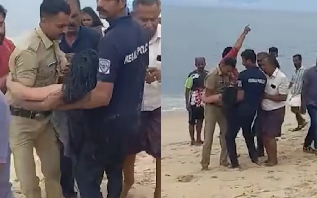 കടലില്‍നിന്ന് രക്ഷപ്പെടുത്തിയ യുവതിയെ കരയിലേക്ക്‌ കൊണ്ടുവരുന്നു | Photo: Screen grab/ Kerala Police
