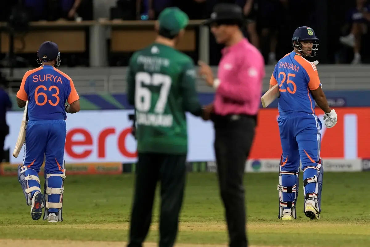 India's captain Suryakumar Yadav, left, and batting partner Shivam Dube, right, leave the field after their win in the Asia Cup cricket match against Pakistan at Dubai International Cricket Stadium in Dubai, United Arab Emirates. | Photo: AFP