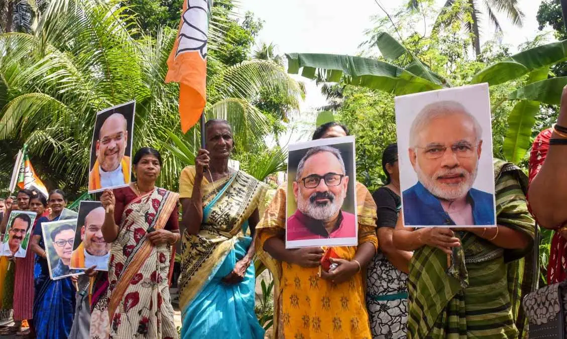 വഖഫ് ഭേദഗതി ബില്‍ പാസാക്കിയതിനെ തുടര്‍ന്ന് പ്രധാനമന്ത്രി നരേന്ദ്ര മോദിയുടെയും ബിജെപി സംസ്ഥാന അധ്യക്ഷന്‍ രാജീവ് ചന്ദ്രശേഖറിന്റെയും പോസ്റ്ററുകളുമായി നില്‍ക്കുന്ന മുനമ്പത്തെ ജനങ്ങള്‍ | Photo: PTI