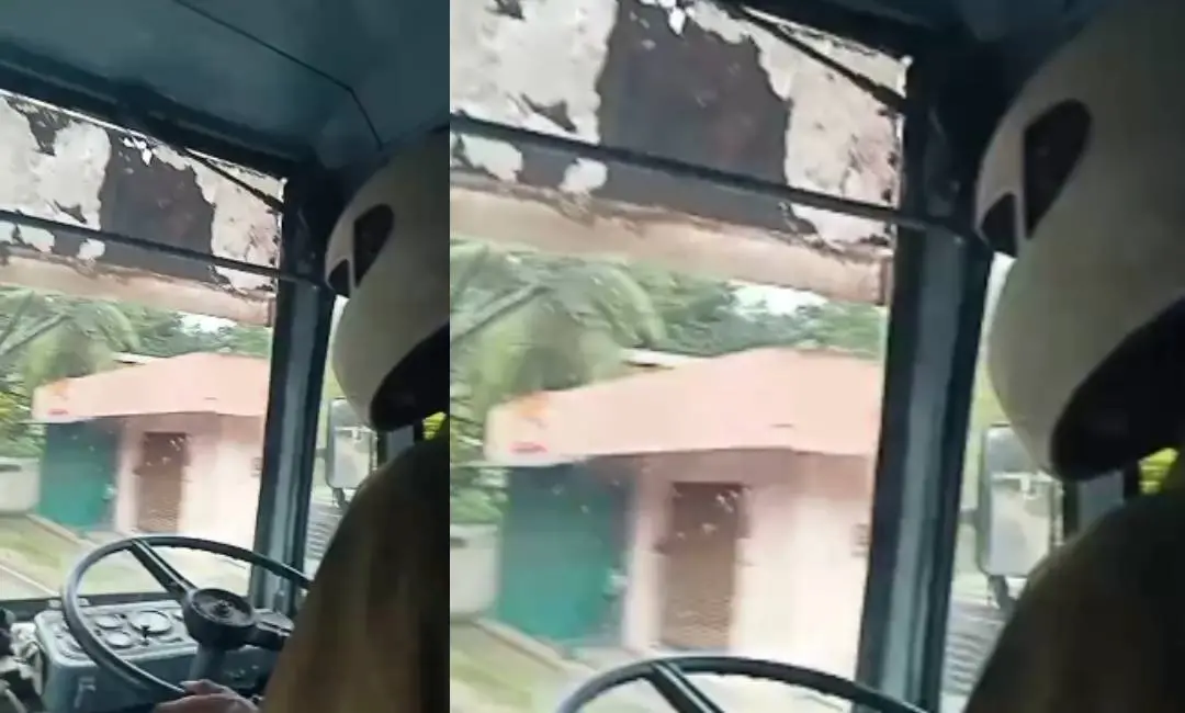ഹെൽമറ്റ് ധരിച്ച് ബസ് ഓടിക്കുന്ന ഡ്രെെവർ