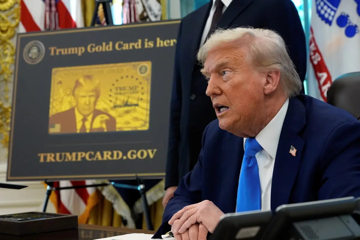 A poster showing the Trump Gold Card is seen as President Donald Trump signs executive orders in the Oval Office of the White House. | Photo: AP