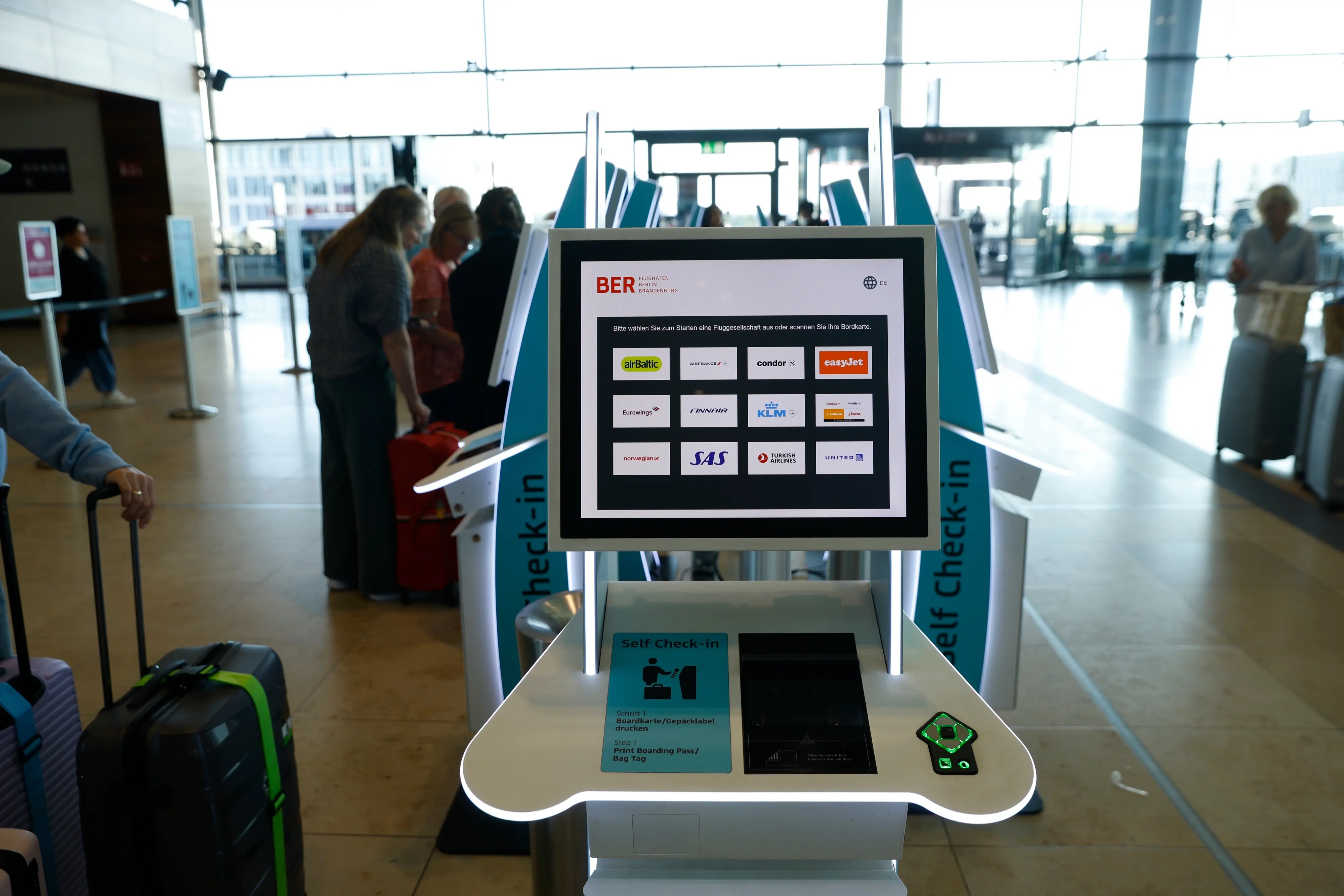 People at BER airport as a cyber attack has caused delays, in Berlin, Germany, Saturday, Sept. 20, 2025. (Carsten Koall/dpa via AP)