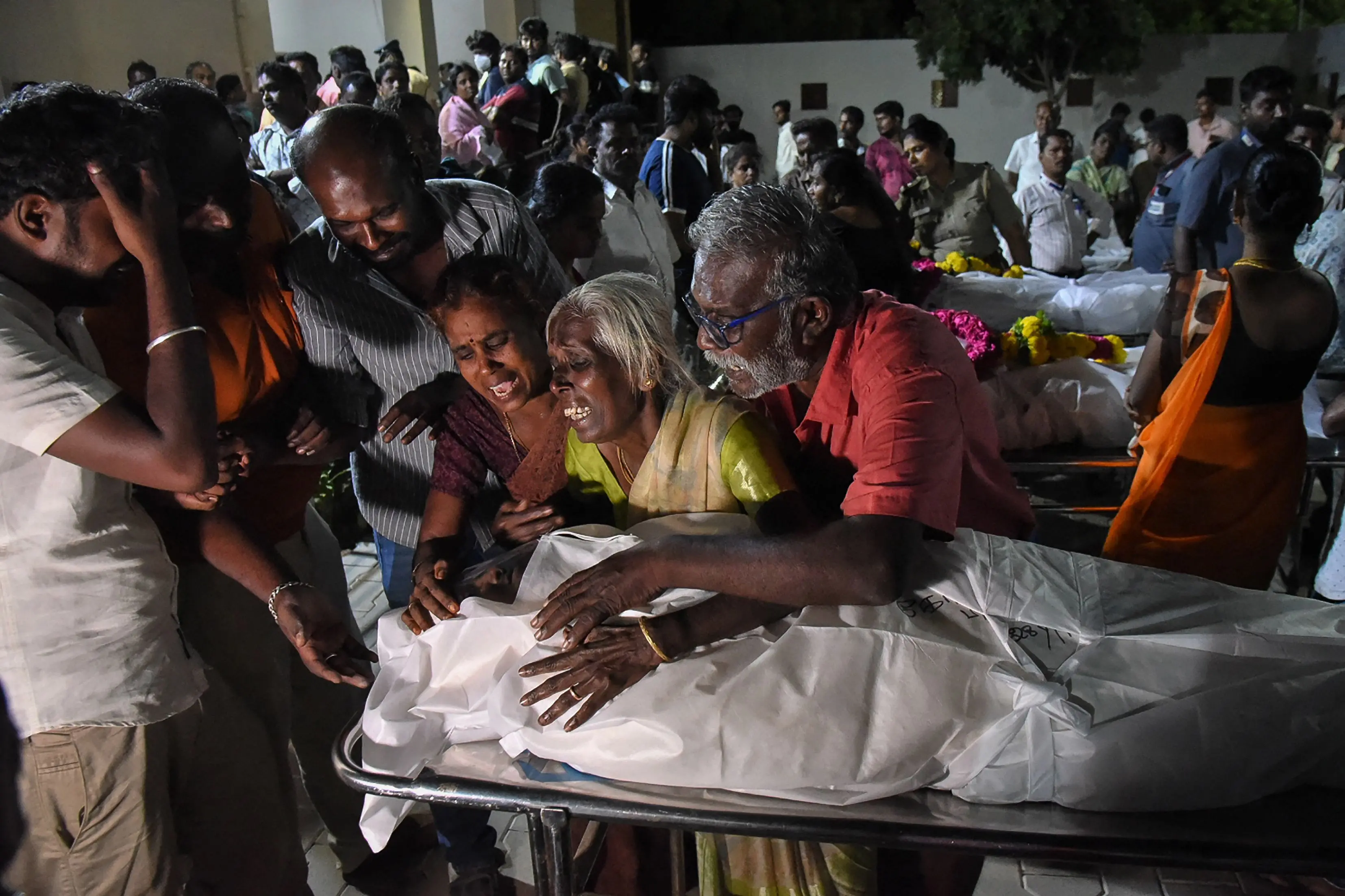 Relatives mourn after receiving the dead body of a victim who was killed in a stampede that broke out during a campaign rally last evening in the Karur district | PTI