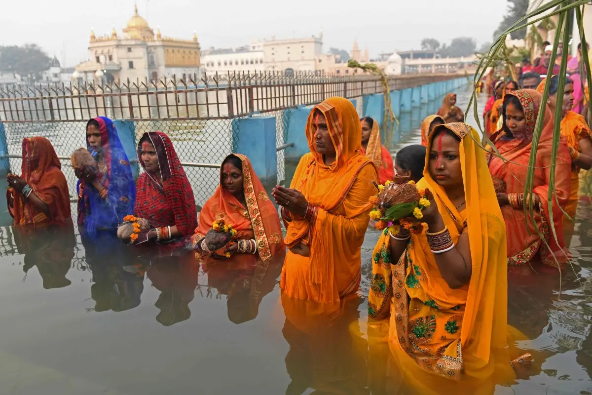 Devotees perform religious rituals as they offer prayers to Sun god on the occasion of the Hindu festival of Chhat Puja