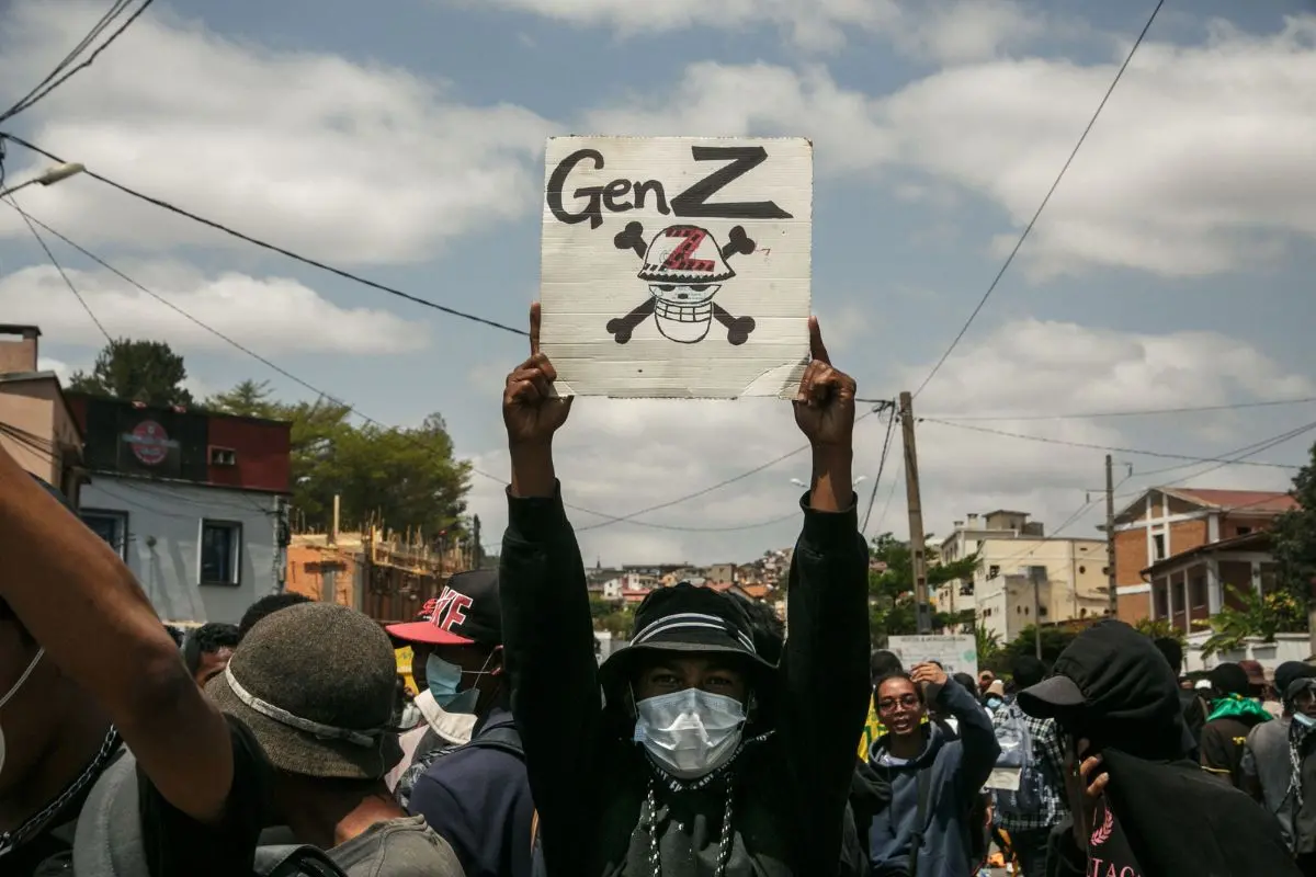A protester holds a placard during a demonstration against repeated water and electricity outages in Antananarivo on September 27, 2025 | Photo: AFP