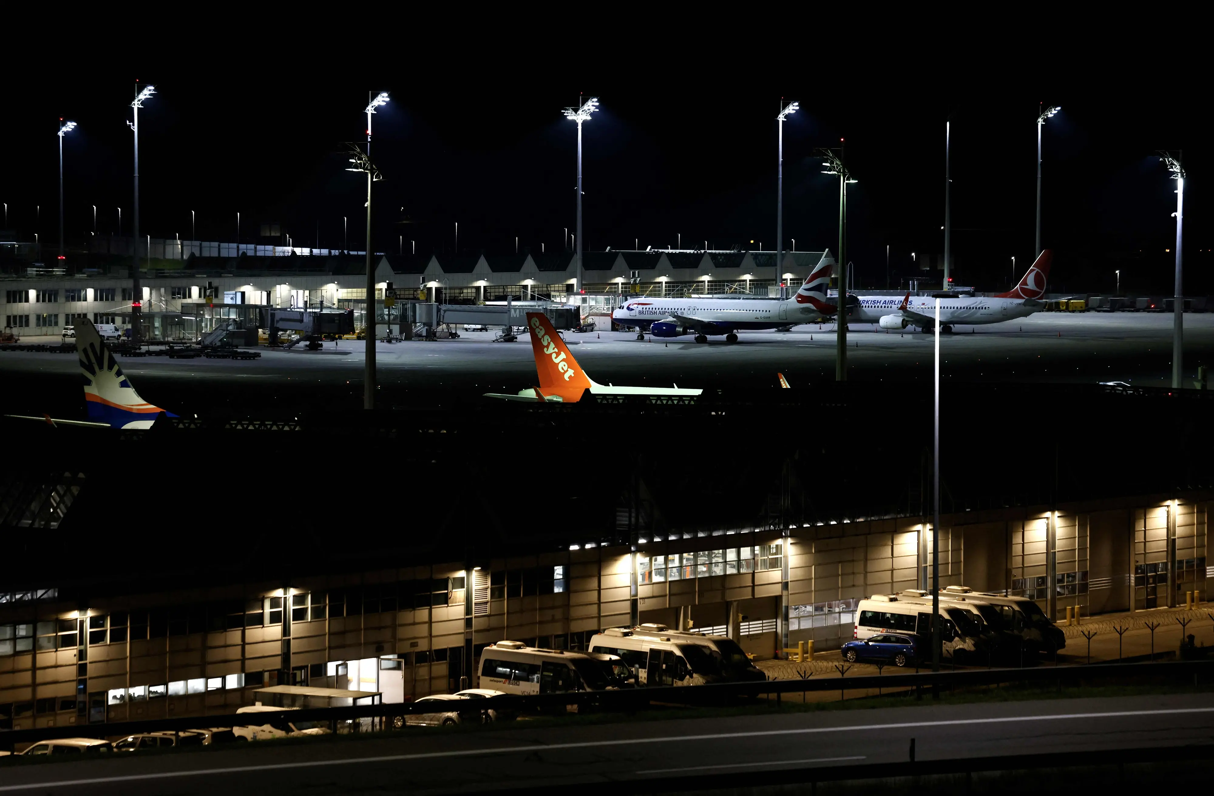 Night view shows a plane of airline EasyJet among others grounded at Munich International Airport in Munich | AFP