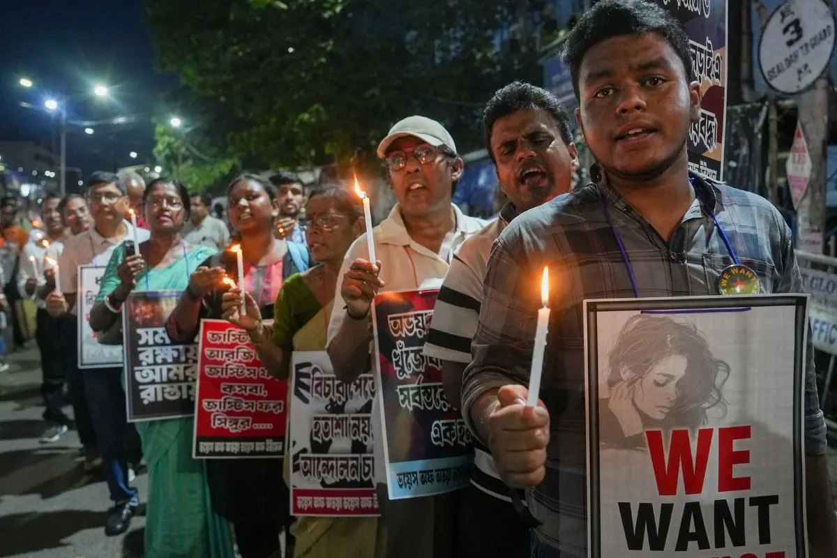 Members of 'Voice of Abhaya, Voice of Women' hold placards during a candlelight vigil on World Protest Day, demanding justice for the RG Kar rape victim and women's safety, in Kolkata. (PTI Photo/Manvender Vashist Lav)