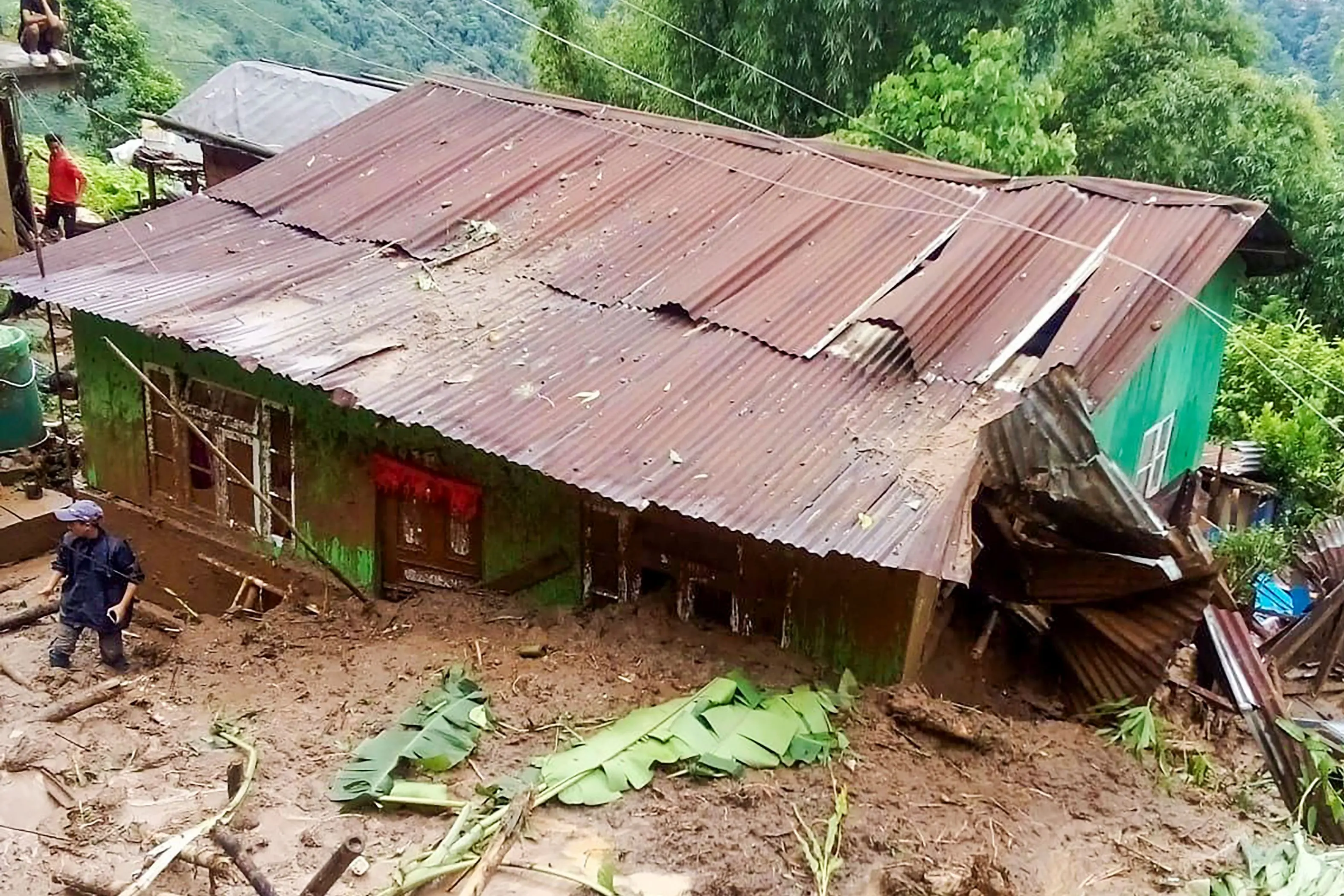 A house partially buried under debris after landslides due to heavy rainfall, in Darjeeling district, West Bengal, Sunday, Oct. 5, 2025. (PTI Photo)