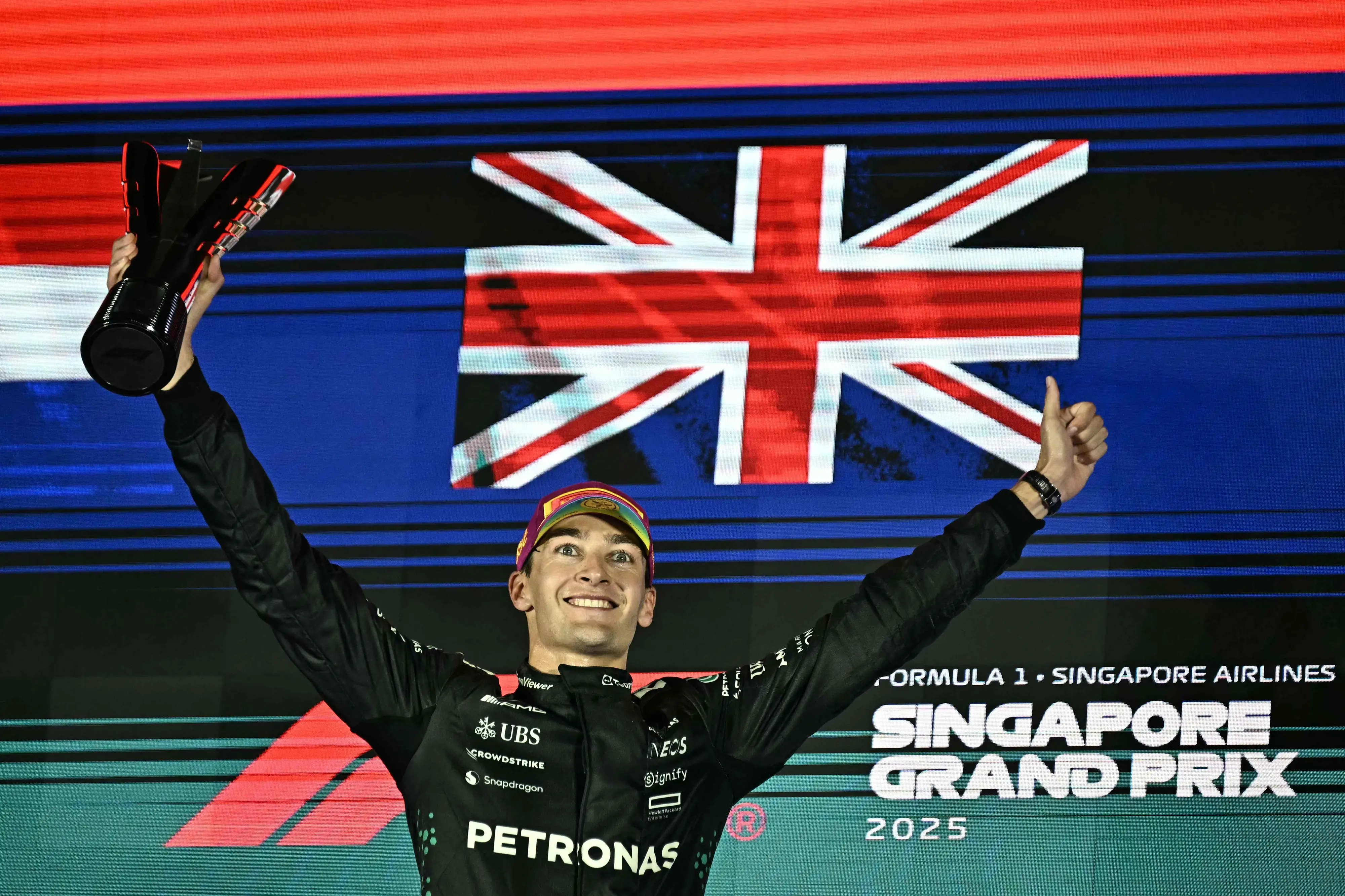 First-placed Mercedes' British driver George Russell celebrates on the podium after the Formula One Singapore Grand Prix night race at the Marina Bay Street Circuit in Singapore. | Photo: AFP