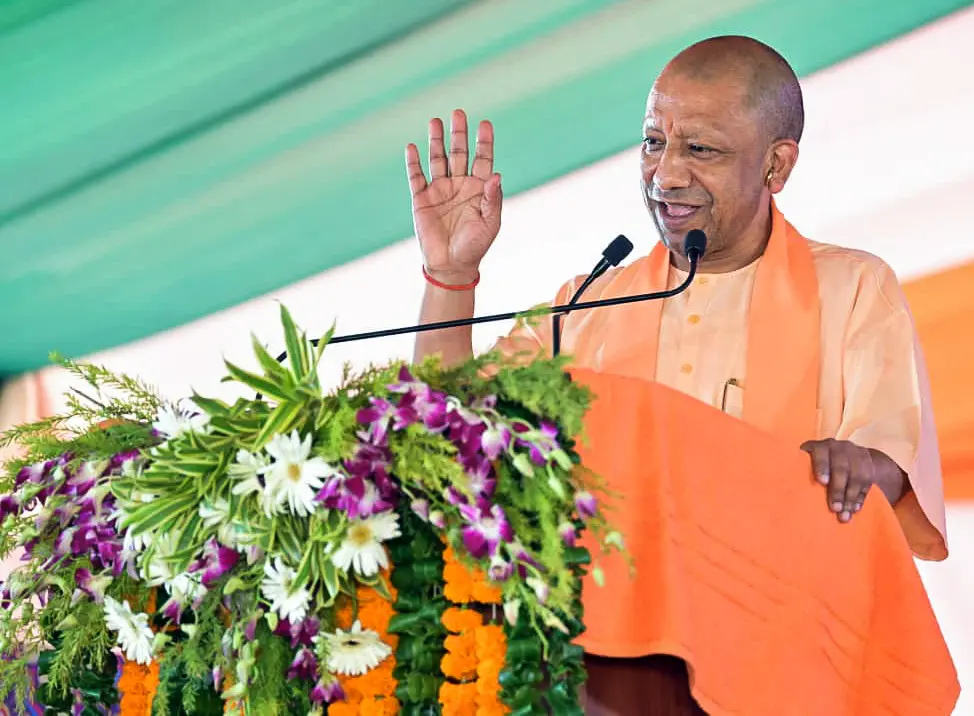 Uttar Pradesh Chief Minister Yogi Adityanath addresses public during the distribution of flat keys under a residential project, in Gorakhpur. | Photo: REUTERS