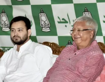 RJD president Lalu Prasad along with son Tejashwi Yadav | PTI