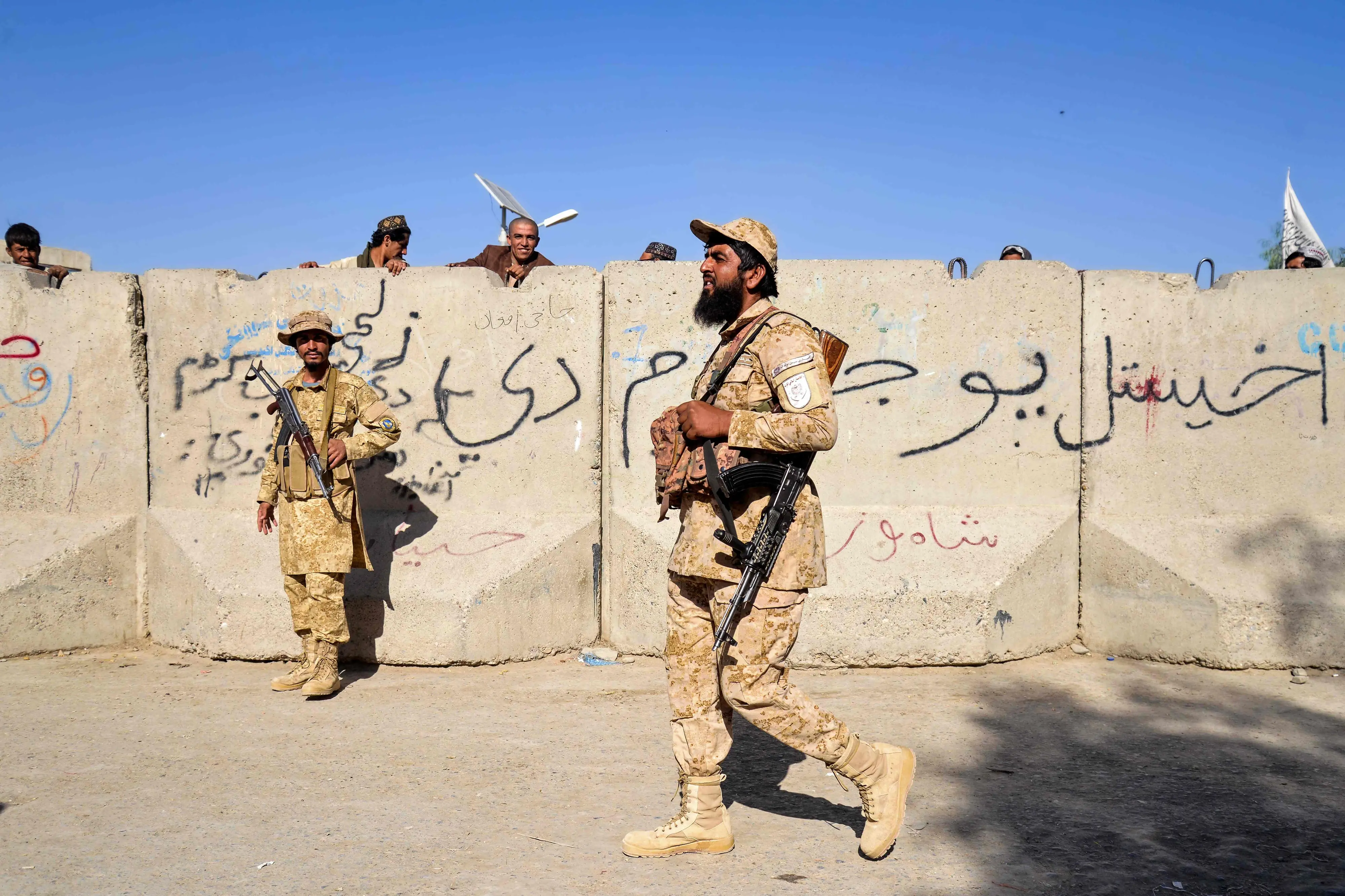 Armed Taliban security personnel keep guard near the closed gate of the zero point border crossing between Afghanistan and Pakistan at Spin Boldak district in Kandahar province. | Photo: AFP